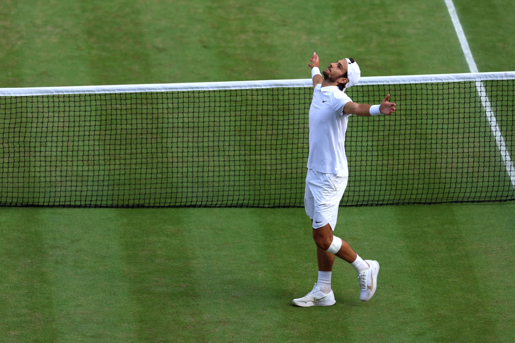 LONDON, ENGLAND - JULY 10: Lorenzo Musetti of Italy celebrates winning match point against Taylor Fritz of United States in the Gentlemen's Singles Quarter Final match during day ten of The Championships Wimbledon 2024 at All England Lawn Tennis and Croquet Club on July 10, 2024 in London, England. (Photo by Sean M. Haffey/Getty Images)