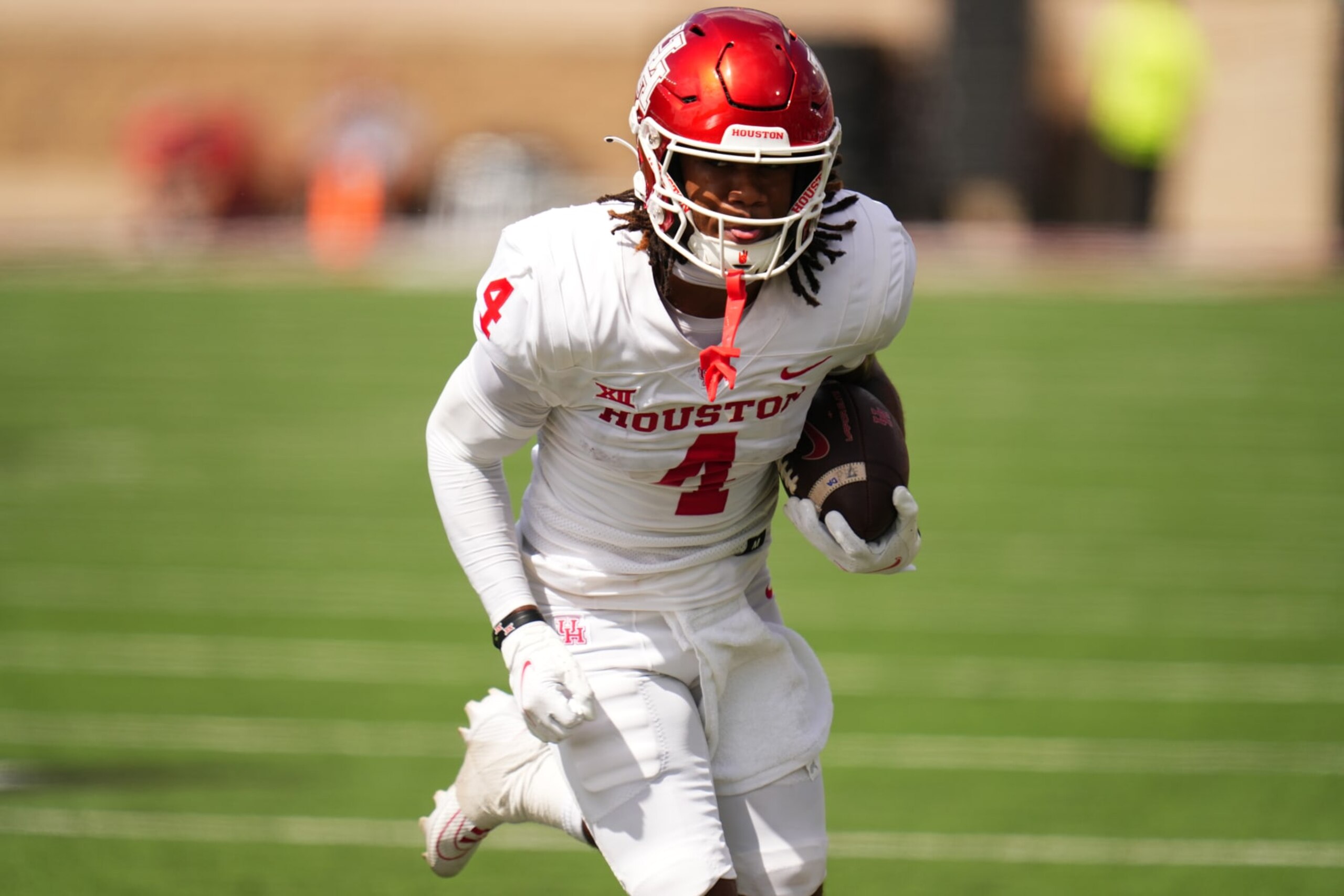 LUBBOCK, TEXAS - SEPTEMBER 30: Samuel Brown #4 of the Houston Cougars runs with the ball during the first quarter against the Texas Tech Red Raiders at Jones AT&T Stadium on September 30, 2023 in Lubbock, Texas. (Photo by Josh Hedges/Getty Images)
