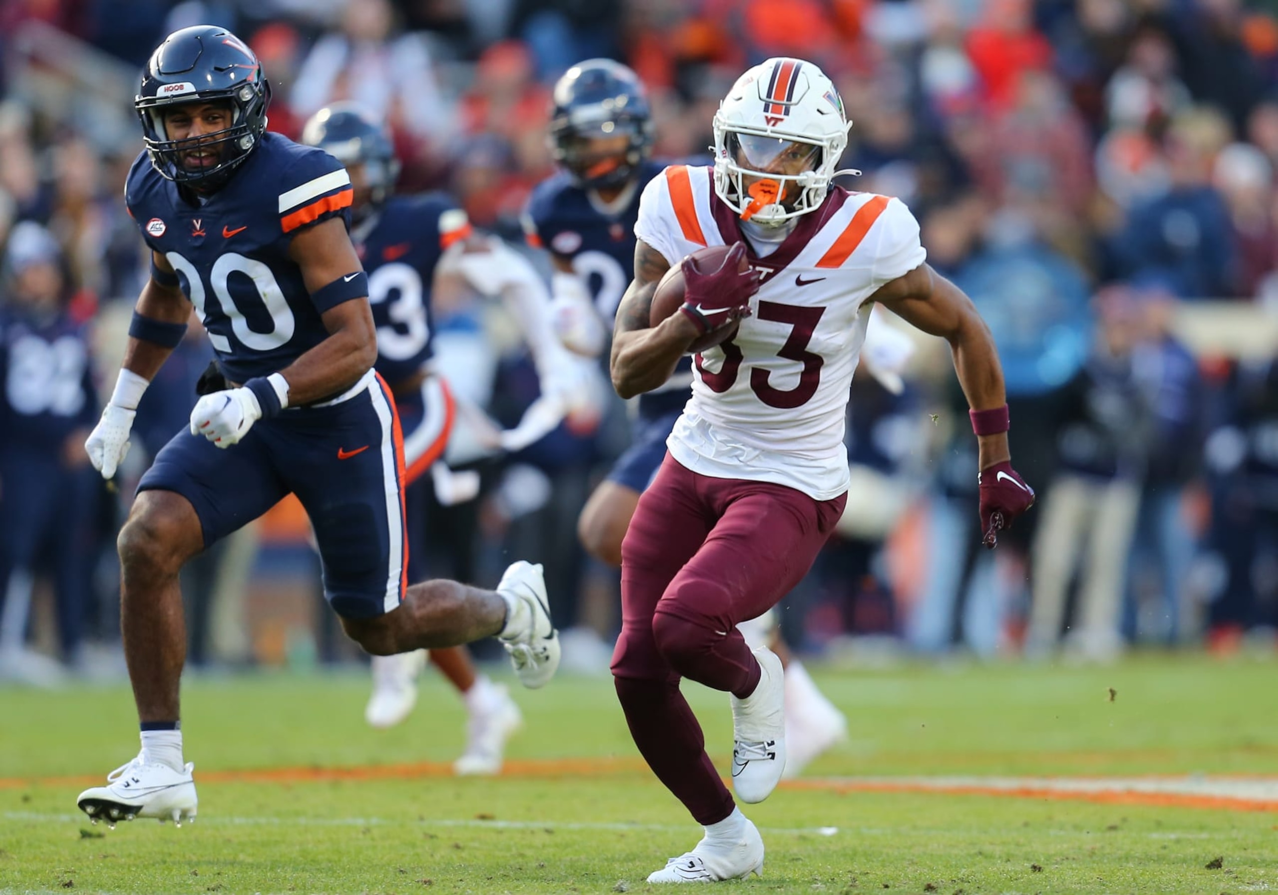 CHARLOTTESVILLE, VA - NOVEMBER 25: Virginia Tech Hokies wide receiver Jaylin Lane (83) hauls in a pass then rushes up field en route to scoring a touchdown while eluding Virginia Cavaliers defensive back Jonas Sanker (20) during a college football game between the Virginia Tech Hokies and the Virginia Cavaliers on November 25, 2023, at Scott Stadium in Charlottesville, VA. (Photo by Lee Coleman/Icon Sportswire via Getty Images)