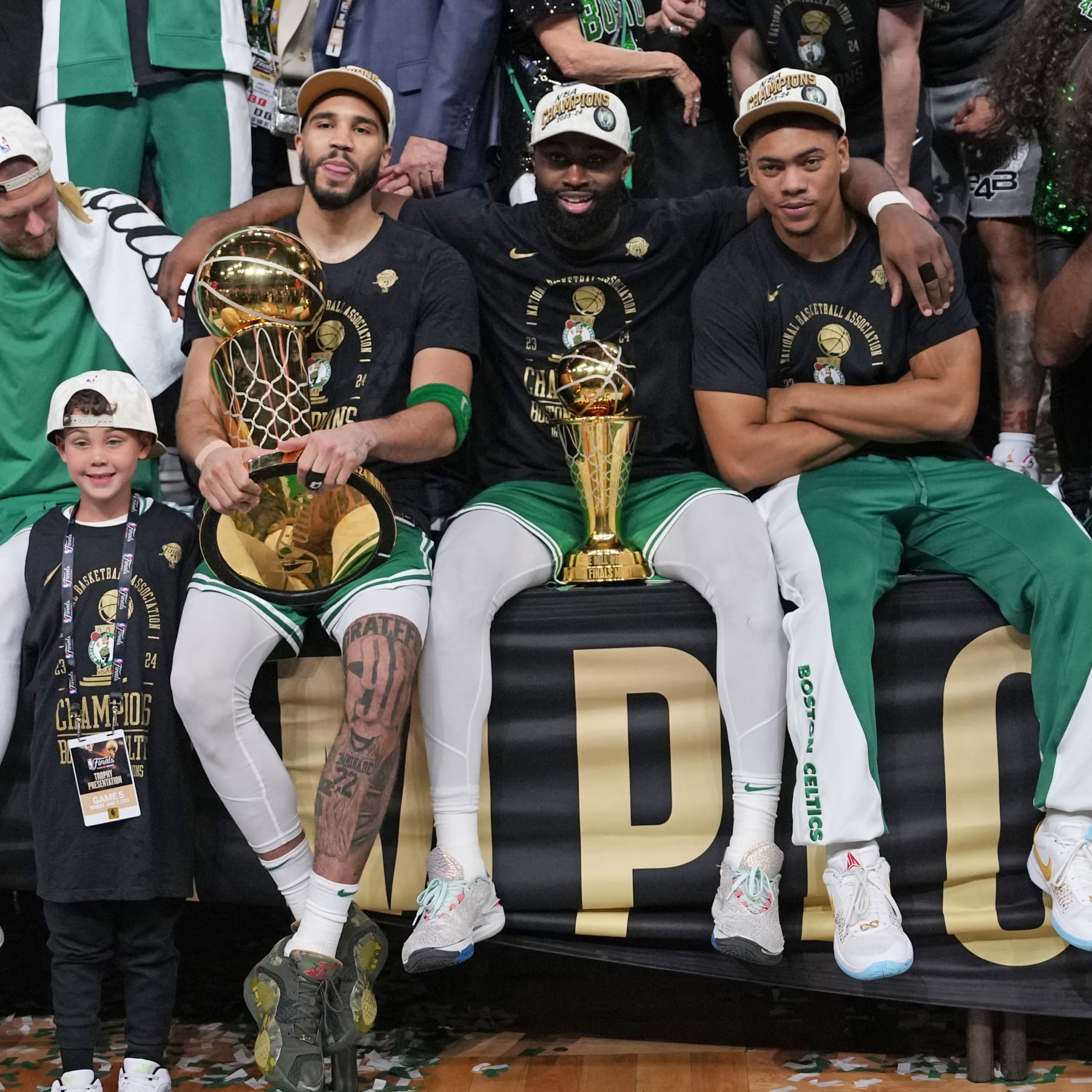 BOSTON, MA - JUNE 17: Jayson Tatum #0 of the Boston Celtics, Jaylen Brown #7 of the Boston Celtics, and Jaden Springer #44 of the Boston Celtics pose for a photo with the Larry O'Brien Trophy and the The Bill Russell Finals MVP Trophy after the game against the Dallas Mavericks during Game 5 of the 2024 NBA Finals on June 17, 2024 at the TD Garden in Boston, Massachusetts. NOTE TO USER: User expressly acknowledges and agrees that, by downloading and or using this photograph, User is consenting to the terms and conditions of the Getty Images License Agreement. Mandatory Copyright Notice: Copyright 2024 NBAE  (Photo by Jesse D. Garrabrant/NBAE via Getty Images)