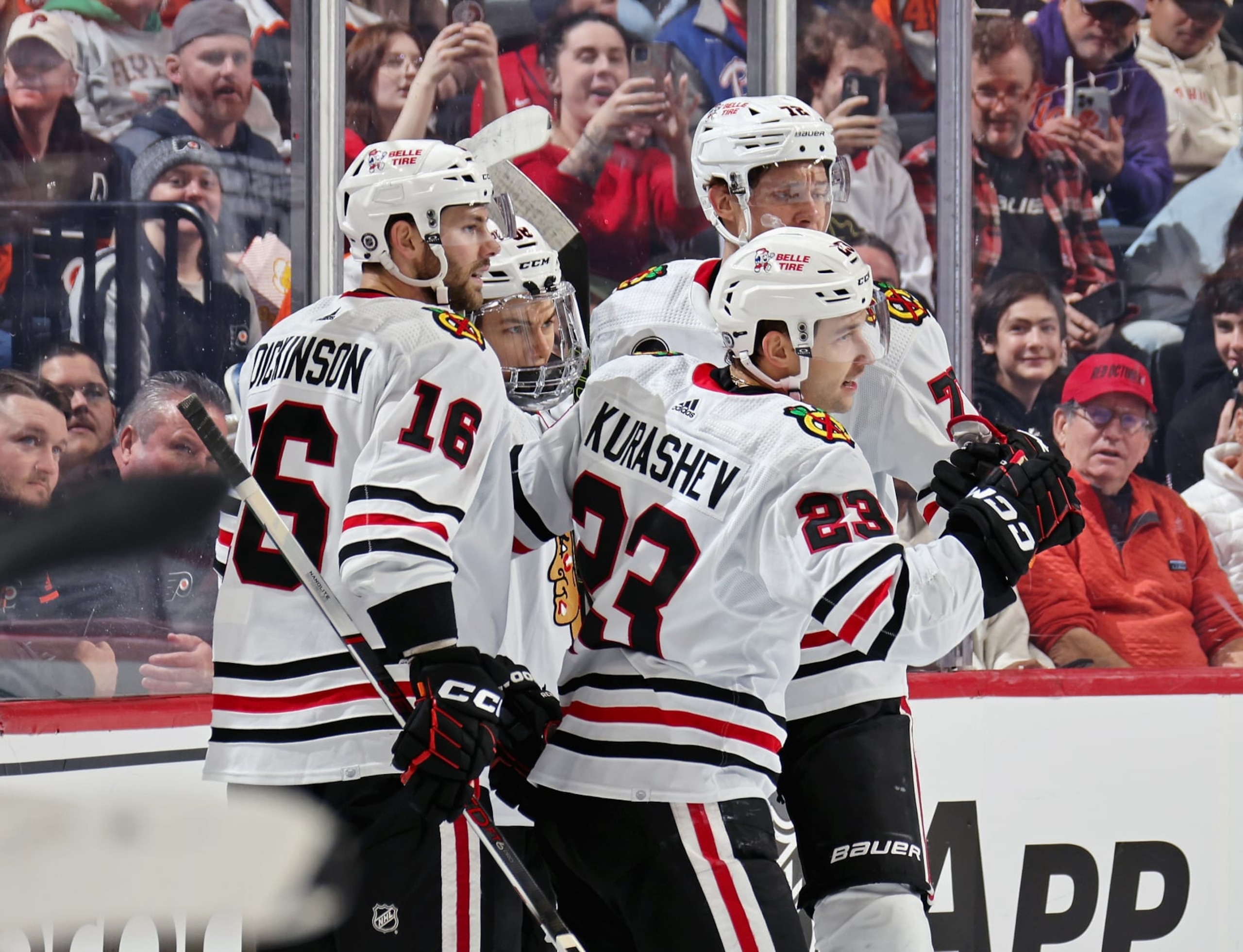 PHILADELPHIA, PENNSYLVANIA - MARCH 30: Philipp Kurashev #23 of the Chicago Blackhawks celebrates his first period goal against the Philadelphia Flyers with Jason Dickinson #16, Connor Bedard #98, and Alex Vlasic #72 at the Wells Fargo Center on March 30, 2024 in Philadelphia, Pennsylvania.  (Photo by Len Redkoles/NHLI via Getty Images)