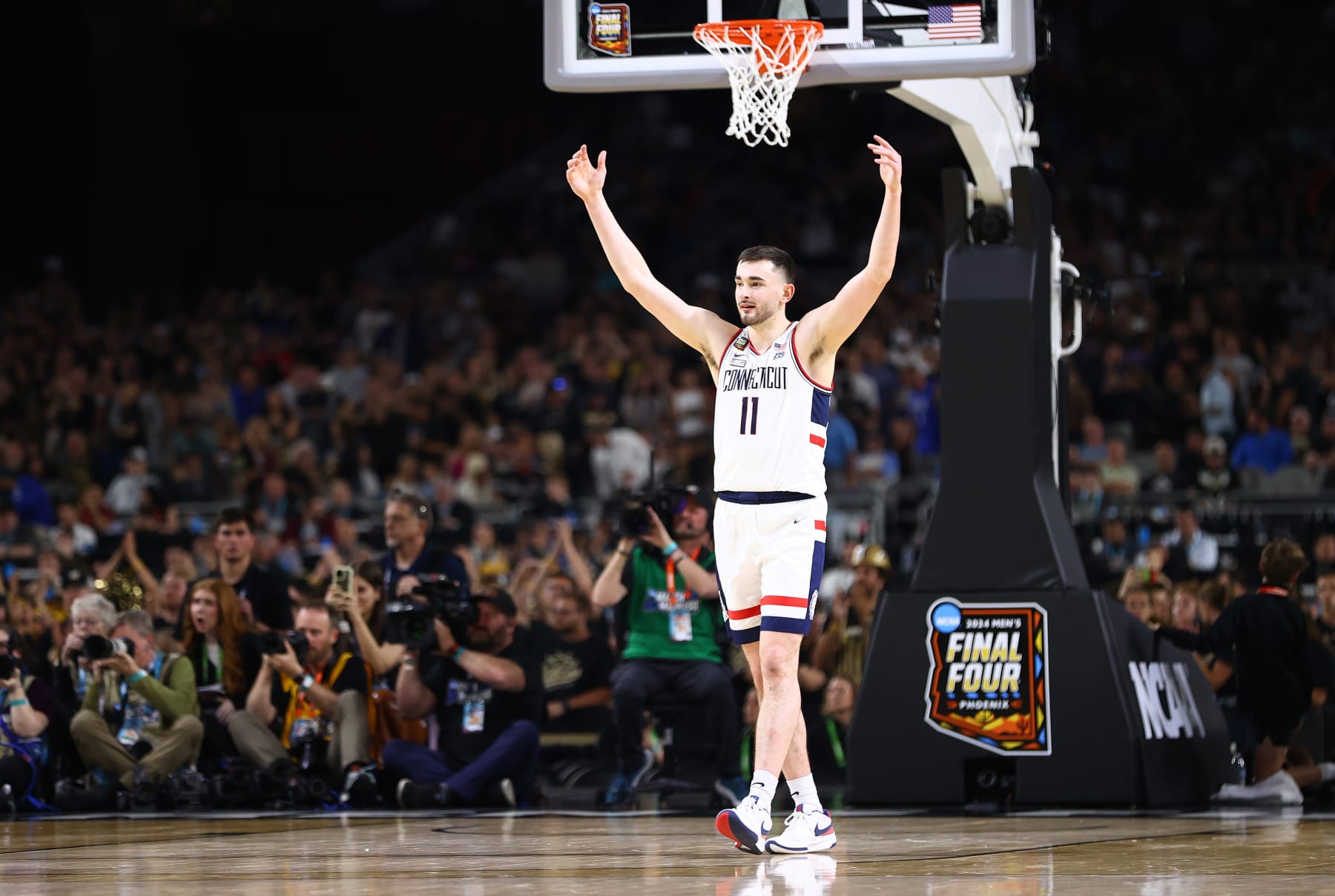 GLENDALE, ARIZONA - APRIL 08: Alex Karaban #11 of the Connecticut Huskies celebrates during the second half in the NCAA Men's Basketball Tournament National Championship game at State Farm Stadium on April 08, 2024 in Glendale, Arizona. (Photo by Jamie Schwaberow/NCAA Photos via Getty Images)