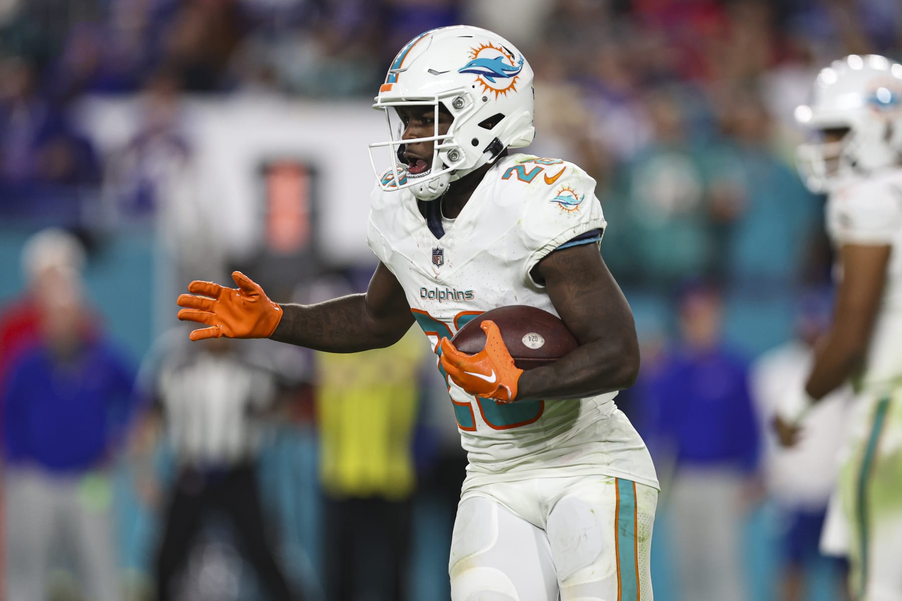 MIAMI GARDENS, FL - JANUARY 07: De'Von Achane #28 of the Miami Dolphins runs the ball during an NFL football game against the Buffalo Bills at Hard Rock Stadium on January 7, 2024 in Miami Gardens, Florida. (Photo by Perry Knotts/Getty Images)