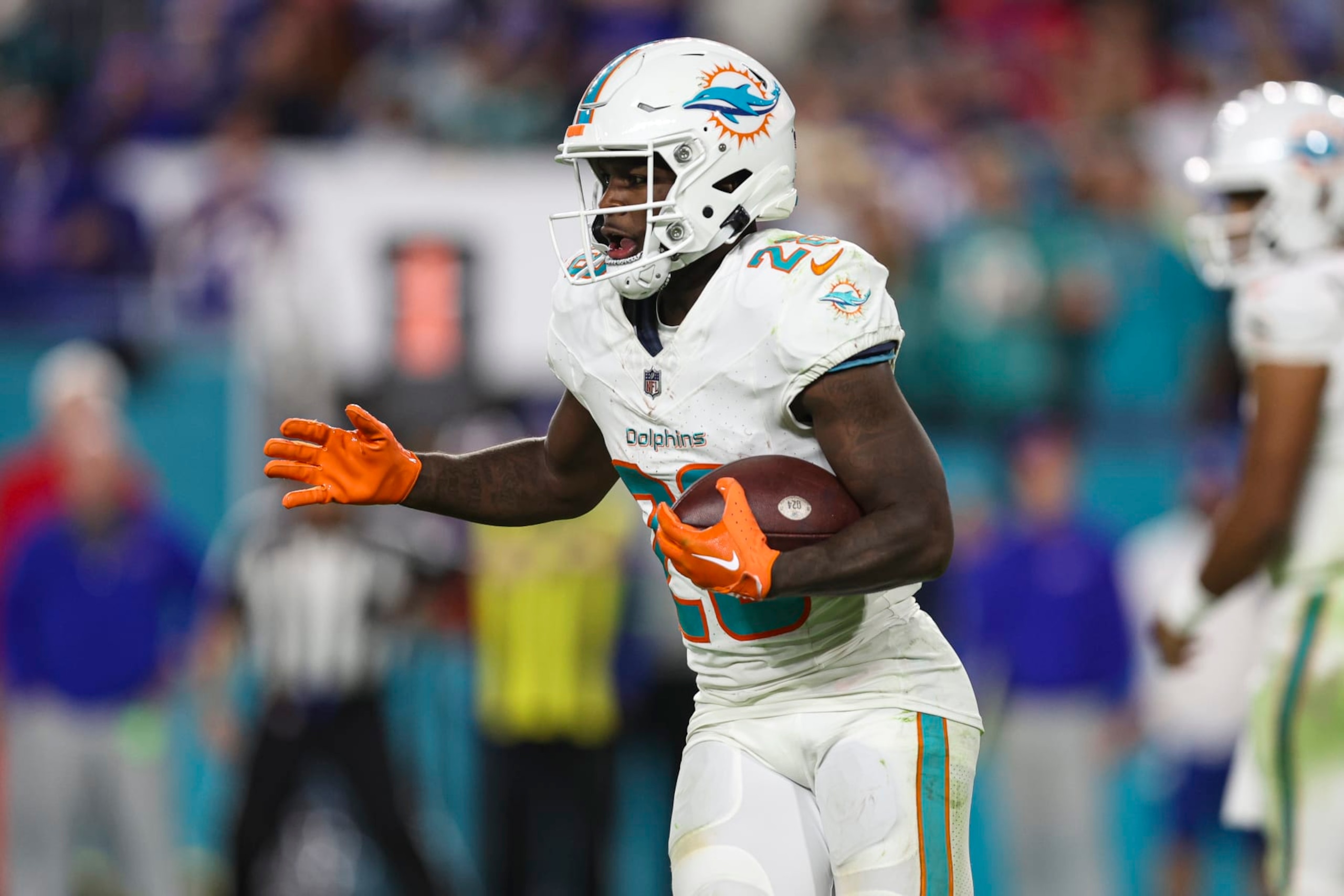 MIAMI GARDENS, FL - JANUARY 07: De'Von Achane #28 of the Miami Dolphins runs the ball during an NFL football game against the Buffalo Bills at Hard Rock Stadium on January 7, 2024 in Miami Gardens, Florida. (Photo by Perry Knotts/Getty Images)