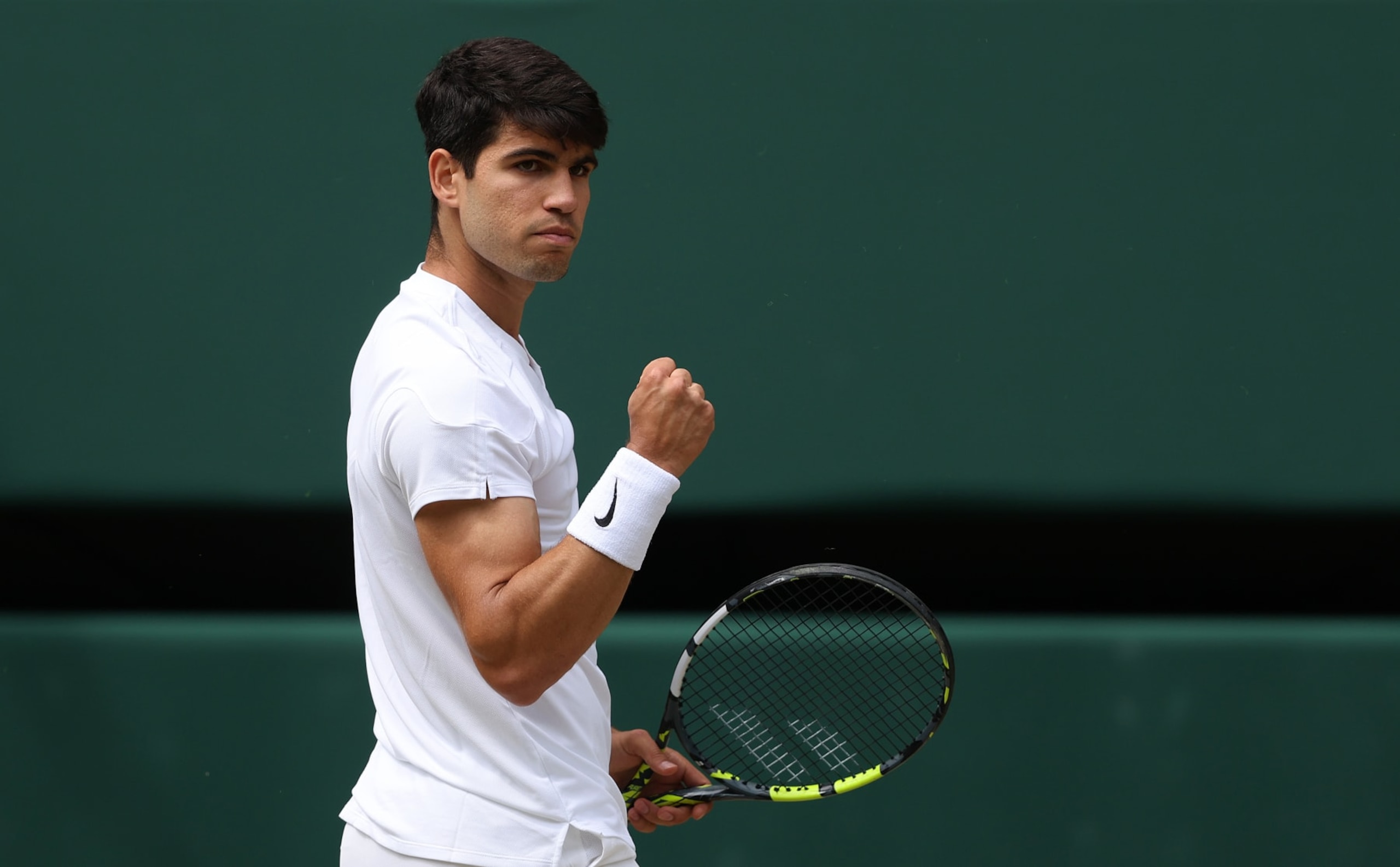 LONDON, ENGLAND - JULY 12: Carlos Alcaraz of Spain celebrates a point against Daniil Medvedev in the Men's Singles Semi-Final match during day twelve of The Championships Wimbledon 2024 at All England Lawn Tennis and Croquet Club on July 12, 2024 in London, England. (Photo by Julian Finney/Getty Images)