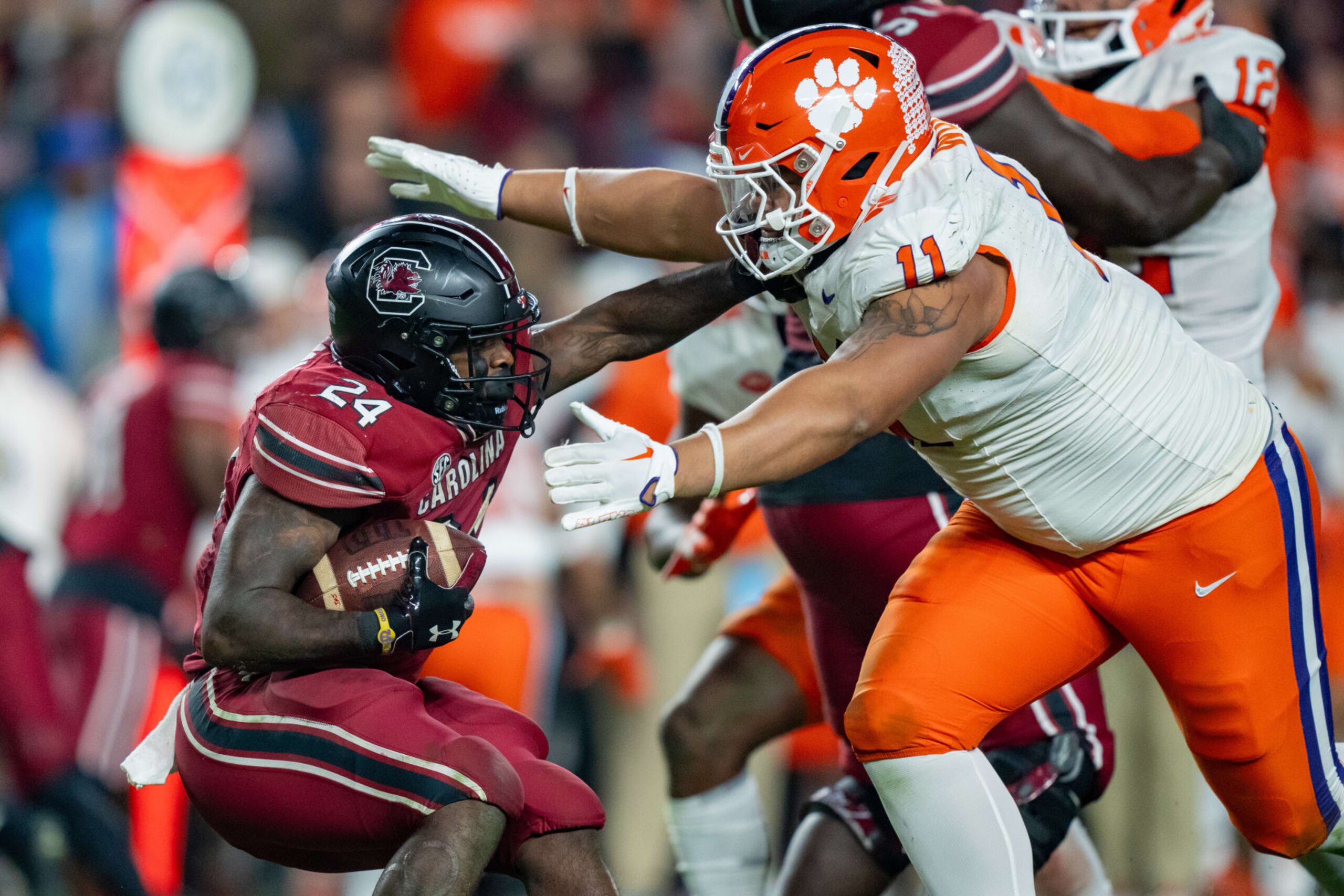 COLUMBIA, SOUTH CAROLINA - NOVEMBER 25: Peter Woods #11 of the Clemson Tigers tries to tackle Mario Anderson #24 of the South Carolina Gamecocks in the third quarter during their game at Williams-Brice Stadium on November 25, 2023 in Columbia, South Carolina. (Photo by Jacob Kupferman/Getty Images) COLUMBIA, SOUTH CAROLINA - NOVEMBER 25: Peter Woods #11 of the Clemson Tigers tries to tackle Mario Anderson #24 of the South Carolina Gamecocks in the third quarter during their game at Williams-Brice Stadium on November 25, 2023 in Columbia, South Carolina. (Photo by Jacob Kupferman/Getty Images)