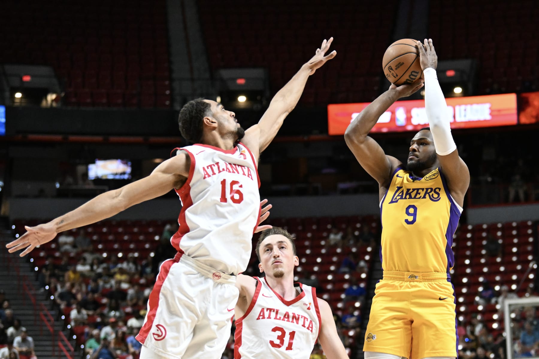 LAS VEGAS, NEVADA - JULY 17: Bronny James Jr. #9 of the Los Angeles Lakers scores against Emmitt Matthews Jr. #16 of the Atlanta Hawks in the first half of a 2024 NBA Summer League game at the Thomas & Mack Center on July 17, 2024 in Las Vegas, Nevada. NOTE TO USER: User expressly acknowledges and agrees that, by downloading and or using this photograph, User is consenting to the terms and conditions of the Getty Images License Agreement. (Photo by Candice Ward/Getty Images)