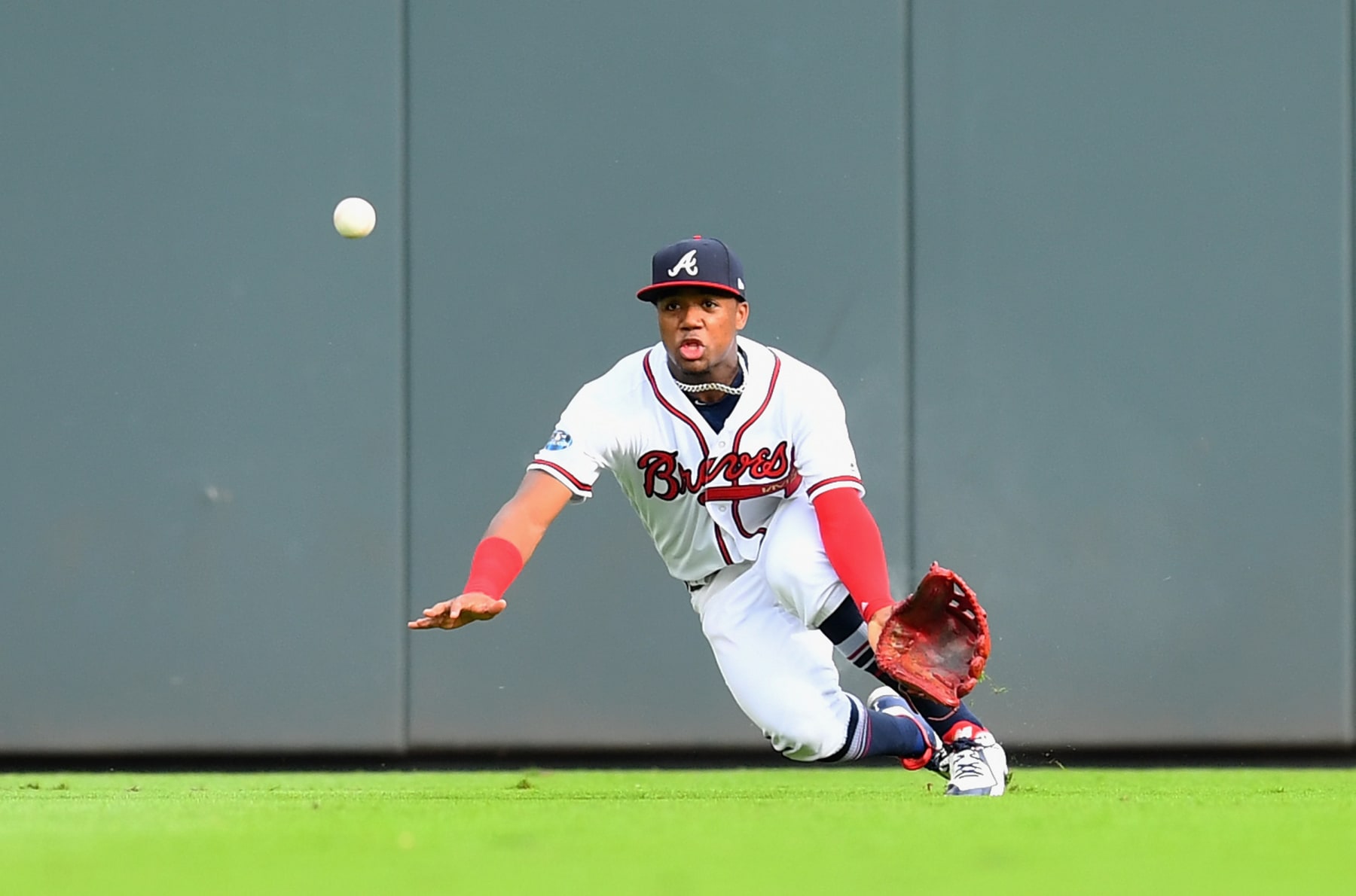 ATLANTA, GA - OCTOBER 08:  Ronald Acuna Jr. #13 of the Atlanta Braves attempts a catch on a hit by Yasiel Puig #66 of the Los Angeles Dodgers during the second inning of Game Four of the National League Division Series at Turner Field on October 8, 2018 in Atlanta, Georgia.  (Photo by Scott Cunningham/Getty Images)