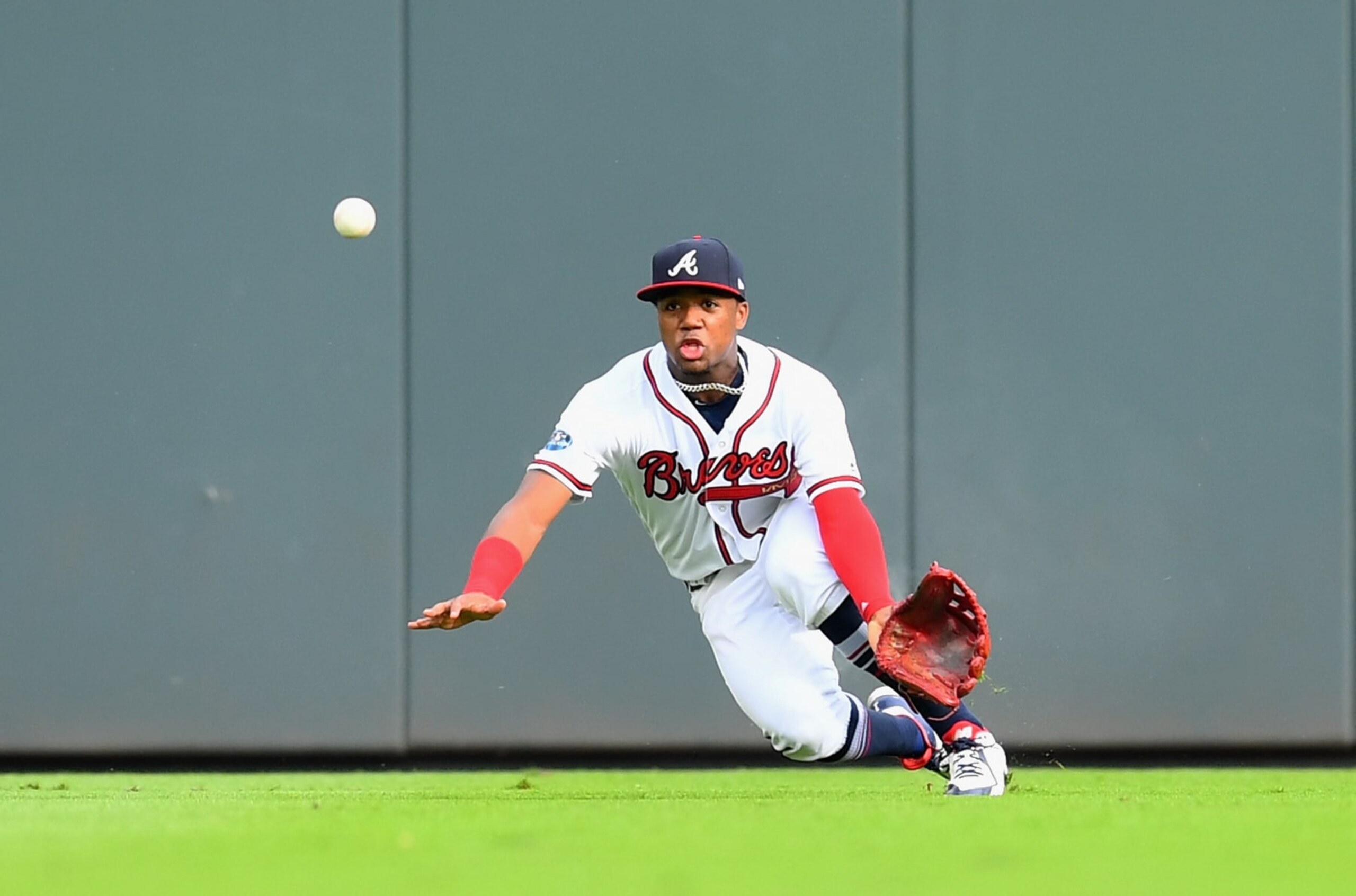 ATLANTA, GA - OCTOBER 08:  Ronald Acuna Jr. #13 of the Atlanta Braves attempts a catch on a hit by Yasiel Puig #66 of the Los Angeles Dodgers during the second inning of Game Four of the National League Division Series at Turner Field on October 8, 2018 in Atlanta, Georgia.  (Photo by Scott Cunningham/Getty Images)
