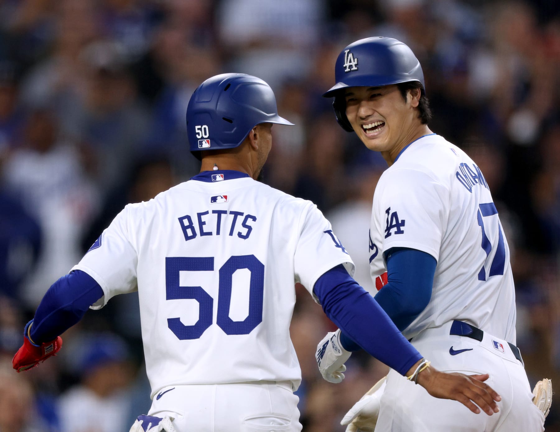 LOS ANGELES, CALIFORNIA - MAY 17: Shohei Ohtani #17 of the Los Angeles Dodgers celebrates his two run home run with Mookie Betts #50 in the third inning, during a 7-3 win over the Cincinnati Reds at Dodger Stadium on May 17, 2024 in Los Angeles, California. (Photo by Harry How/Getty Images)