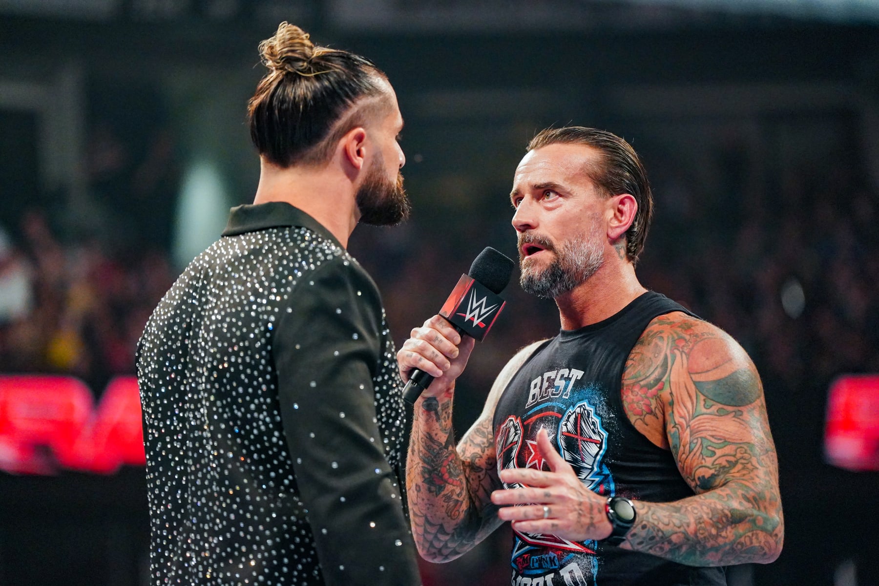 OTTAWA, CANADA - JULY 8: Seth Rollins and CM Punk have a chat in the ring during Monday Night RAW at Canadian Tire Centre on July 8, 2024 in Ottawa, Ontario. (Photo by WWE/Getty Images)