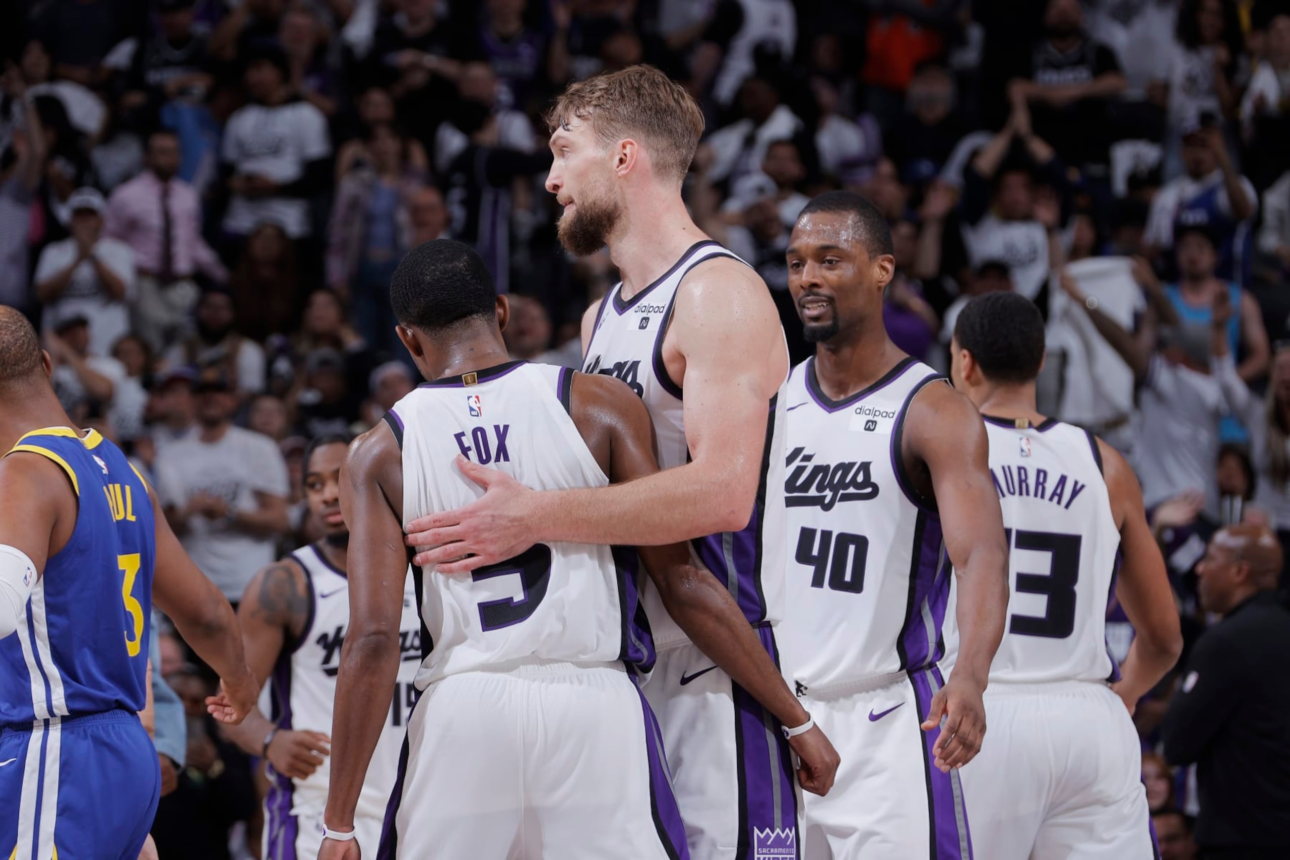 SACRAMENTO, CA - APRIL 16: De'Aaron Fox #5 and Domantas Sabonis #10 of the Sacramento Kings hug during the game against the Golden State Warriors during the 2024 Play-In Tournament on April 16, 2024 at Golden 1 Center in Sacramento, California. NOTE TO USER: User expressly acknowledges and agrees that, by downloading and or using this photograph, User is consenting to the terms and conditions of the Getty Images Agreement. Mandatory Copyright Notice: Copyright 2024 NBAE (Photo by Rocky Widner/NBAE via Getty Images)