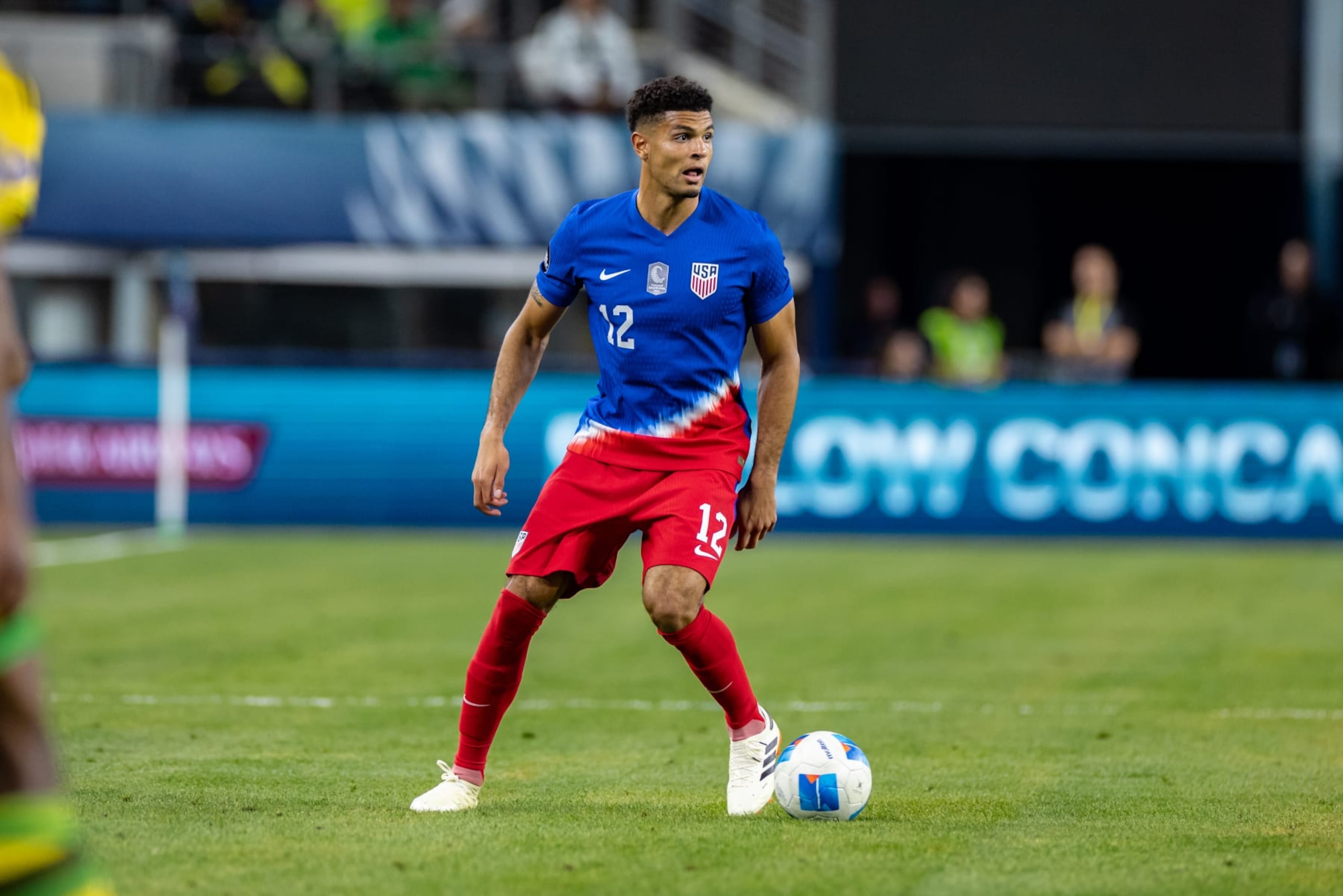 ARLINGTON, TX - MARCH 21: United States defender Miles Robinson (#12) looks up field during the Concacaf Nations League semi final match between the United States and Jamaica on March 21, 2024 at AT&T Stadium in Arlington, Texas.  (Photo by Matthew Visinsky/Icon Sportswire via Getty Images)