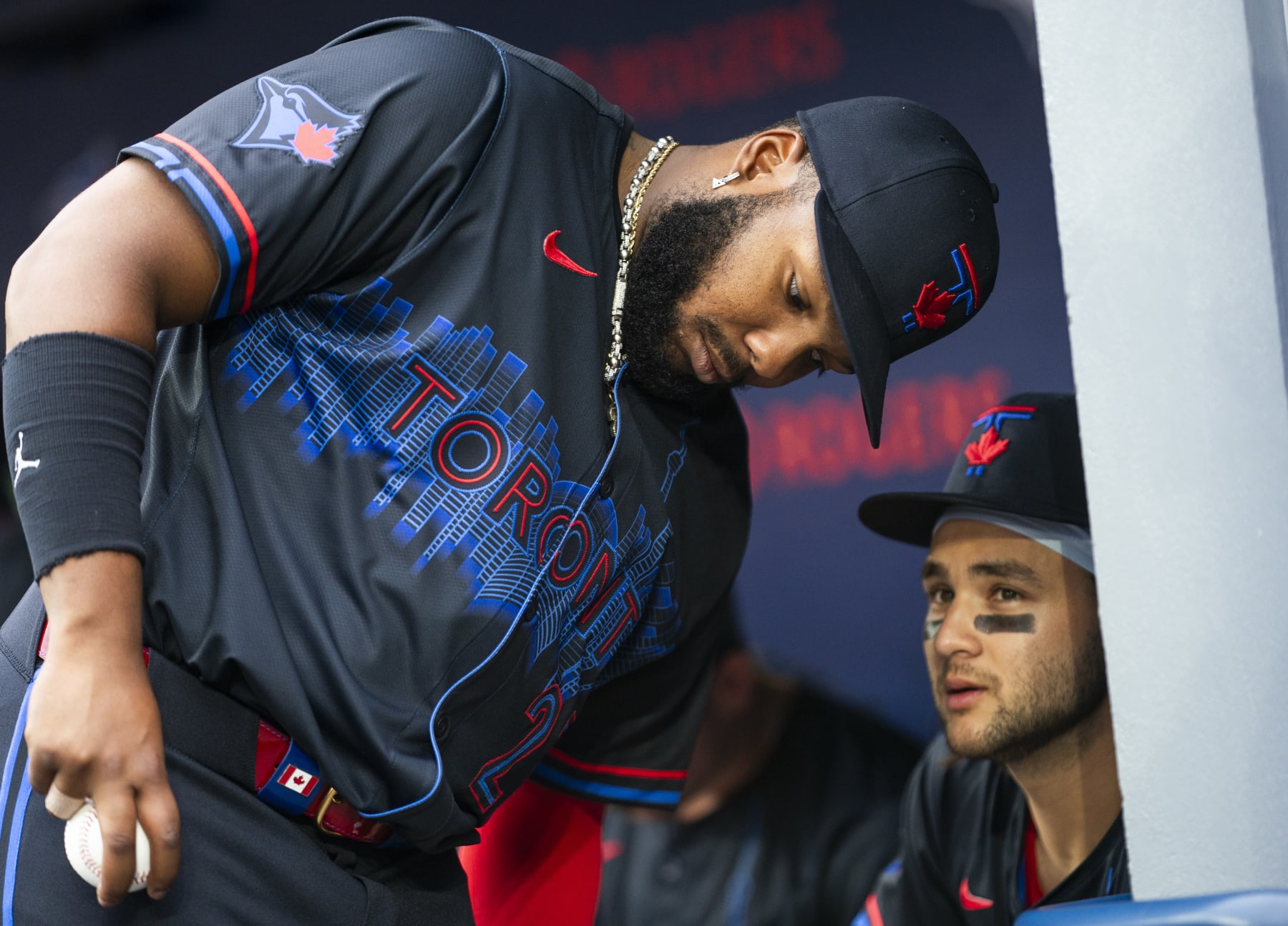 TORONTO, ON - JULY 3: Vladimir Guerrero Jr. #27 and Bo Bichette #11 of the Toronto Blue Jays speak in the dugout before playing the Houston Astros in their MLB game at the Rogers Centre on July 3, 2024 in Toronto, Ontario, Canada. (Photo by Mark Blinch/Getty Images)
