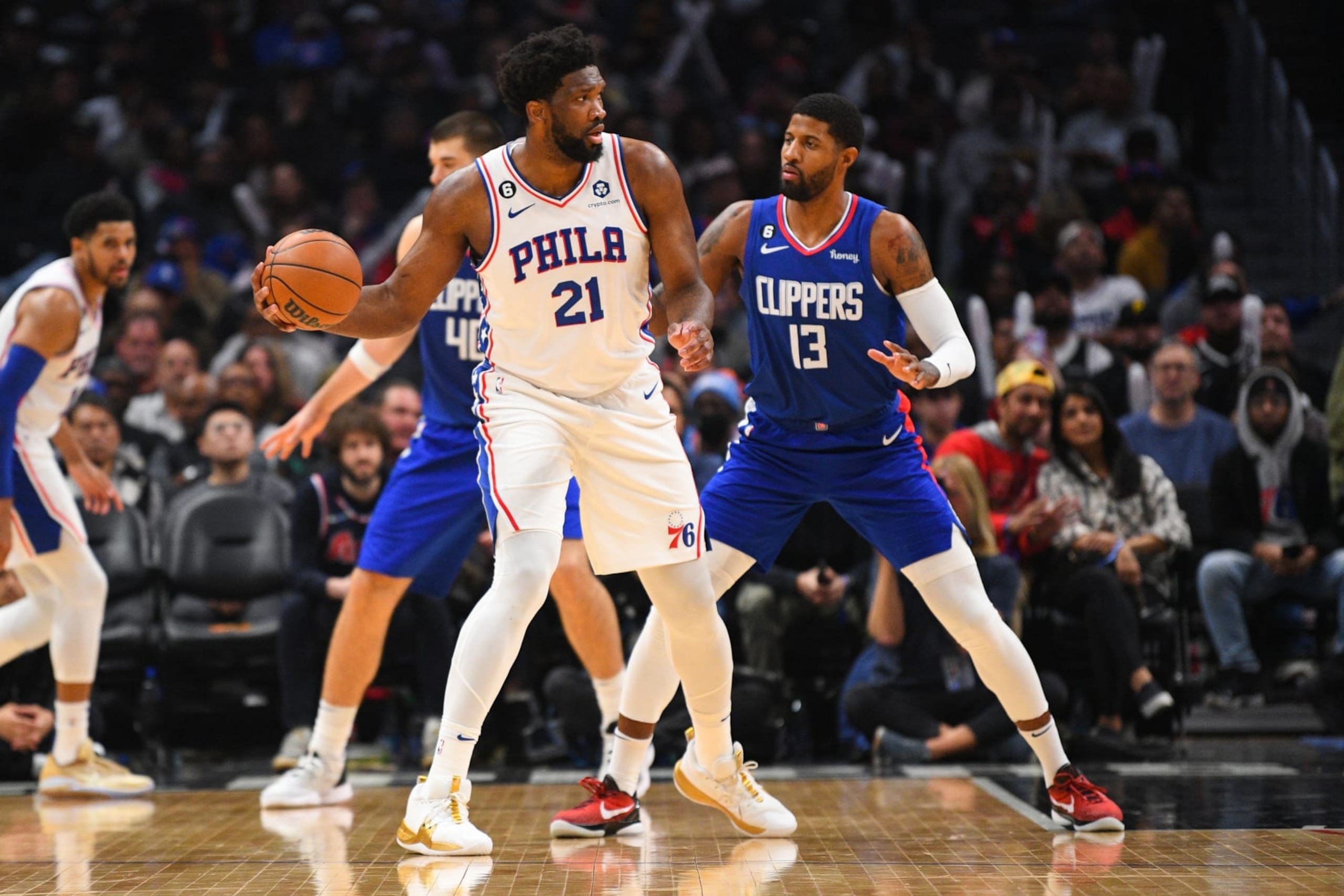 LOS ANGELES, CA - JANUARY 17: Philadelphia 76ers Center Joel Embiid (21) is guarded by Los Angeles Clippers Forward Paul George (13) during a NBA game between the Philadelphia 76ers and the Los Angeles Clippers on January 17, 2023 at Crypto.com Arena in Los Angeles, CA. (Photo by Brian Rothmuller/Icon Sportswire via Getty Images)