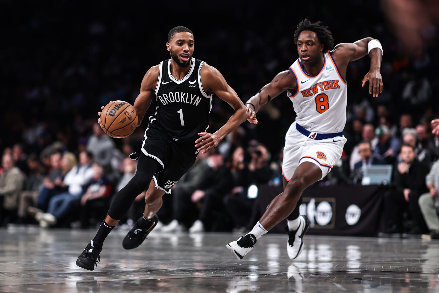 NEW YORK, NEW YORK - JANUARY 23: Mikal Bridges #1 of the Brooklyn Nets is defended by OG Anunoby #8 of the New York Knicks during the first quarter of the game at Barclays Center on January 23, 2024 in New York City. NOTE TO USER: User expressly acknowledges and agrees that, by downloading and or using this photograph, User is consenting to the terms and conditions of the Getty Images License Agreement. (Photo by Dustin Satloff/Getty Images)