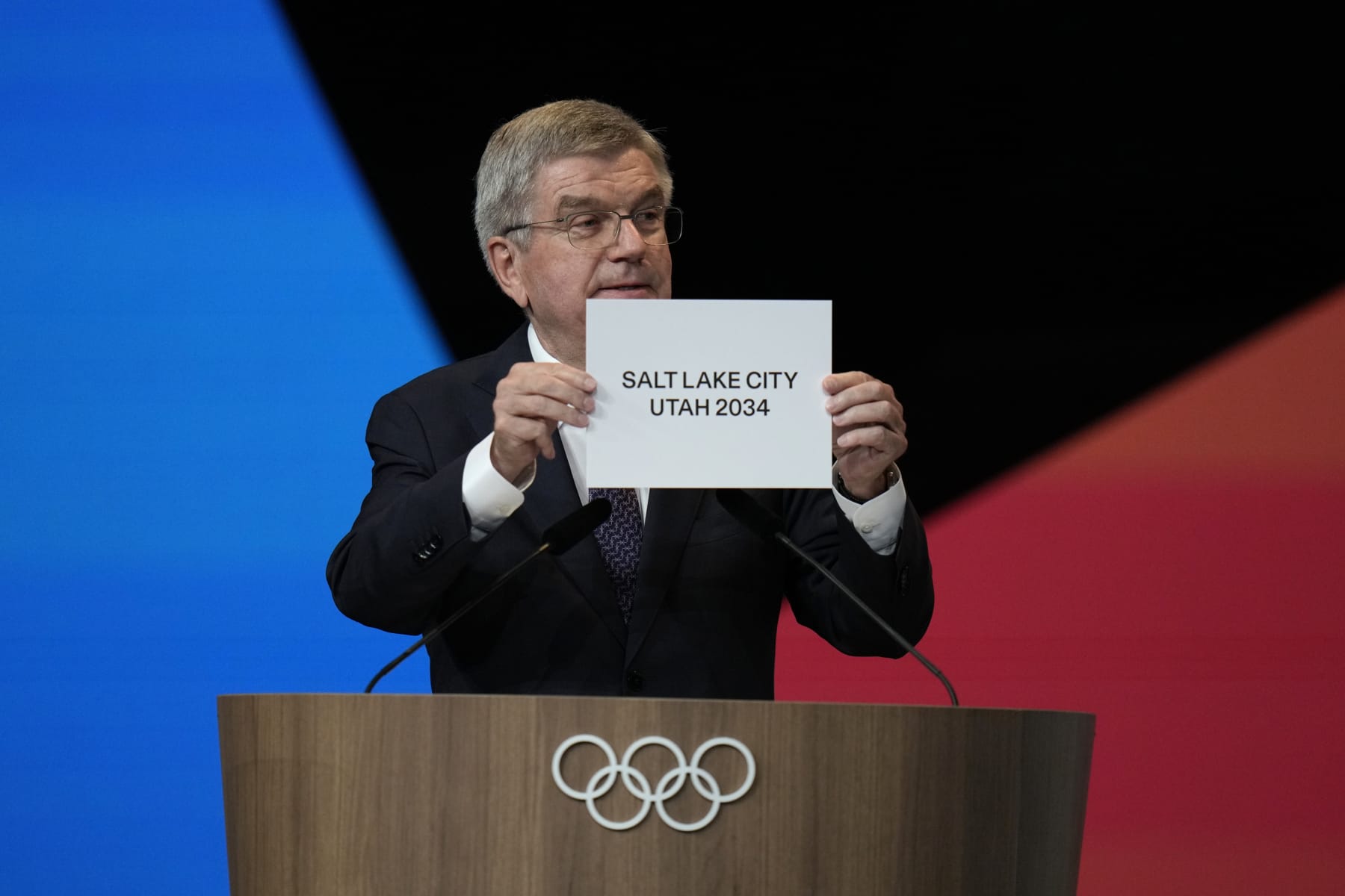 PARIS, FRANCE - JULY 24: IOC president Thomas Bach holds the board Salt Lake City during the 142nd IOC session at the 2024 Summer Olympics on July 24, 2024 in Paris, France. Salt Lake City was confirmed as host for the 2034 Winter Games by International Olympic Committee. (Photo by Natacha Pisarenko - Pool/Getty Images)