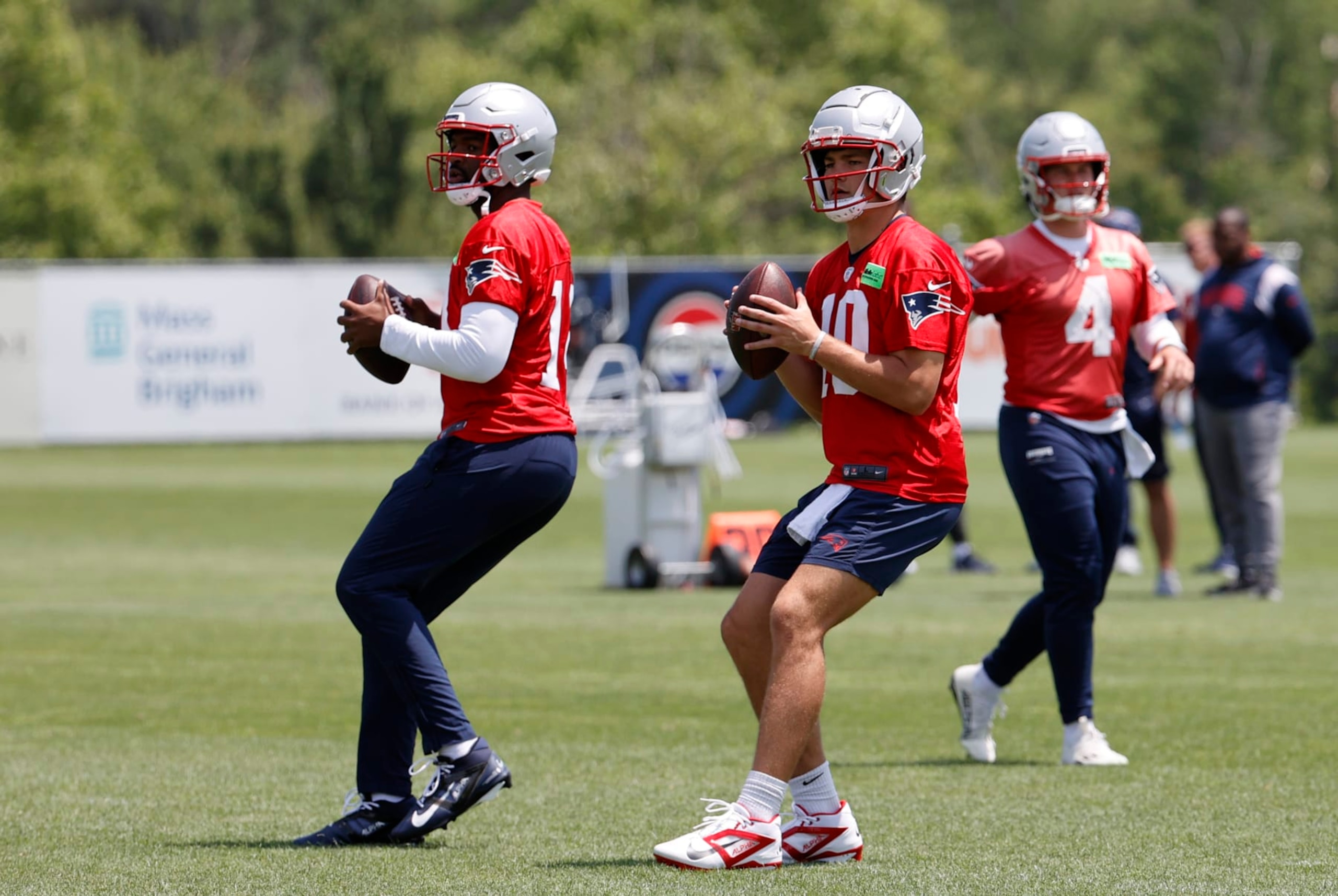 FOXBOROUGH, MA - JUNE 04: New England Patriots quarterbacks Jacoby Brissett (14) and Drake Maye (10) drop back during New England Patriots OTA on June 4, 2024, at Gillette Stadium in Foxborough, Massachusetts. (Photo by Fred Kfoury III/Icon Sportswire via Getty Images)