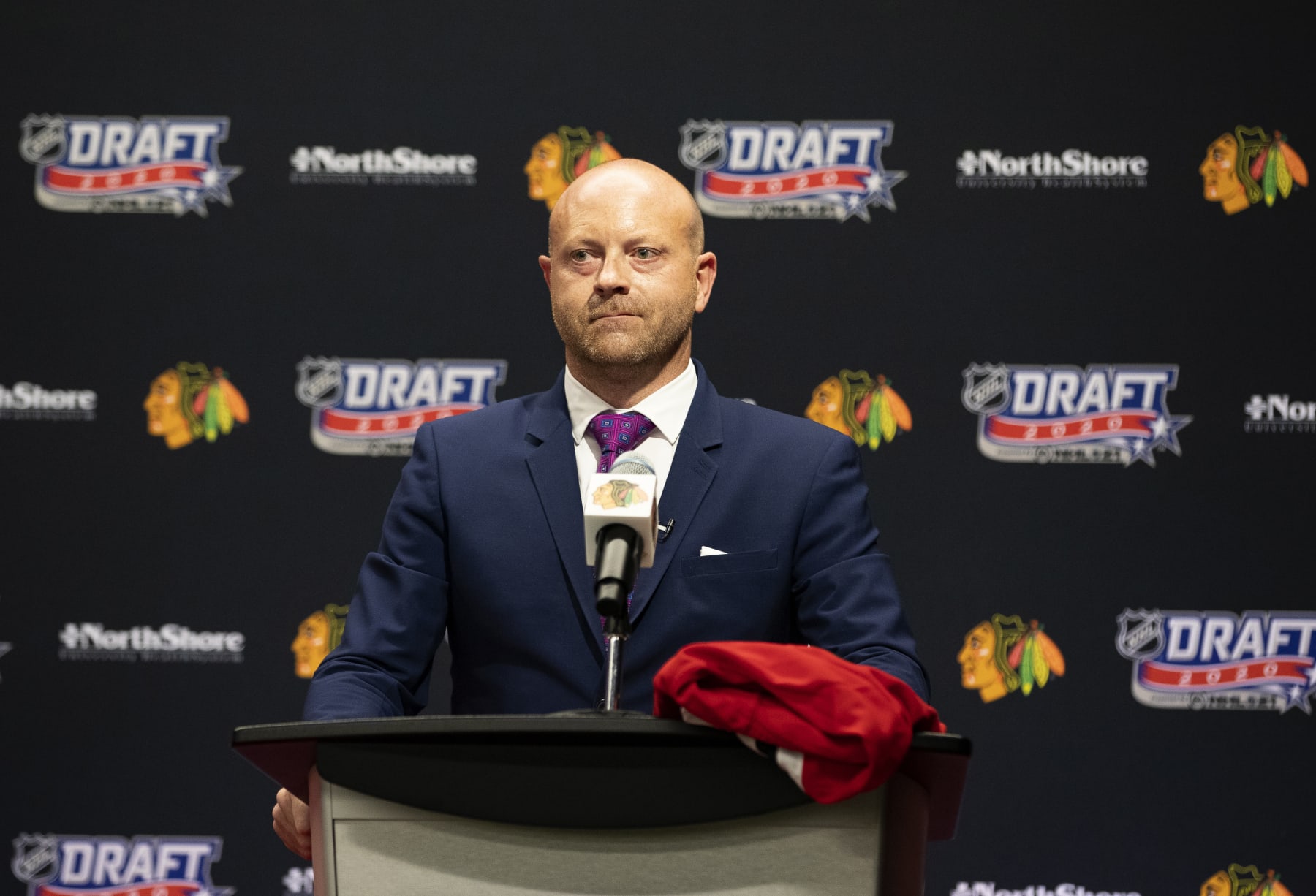 CHICAGO, ILLINOIS - OCTOBER 06: Vice president and general manager Stan Bowman of the Chicago Blackhawks speaks from the podium before their 17th overall pick in the first round of the 2020 NHL Entry Draft at Fifth Third Arena on October 06, 2020 in Chicago, Illinois. The 2020 NHL Draft was held virtually due to the ongoing Coronavirus pandemic. (Photo by Taylor Wilder/NHLI via Getty Images)