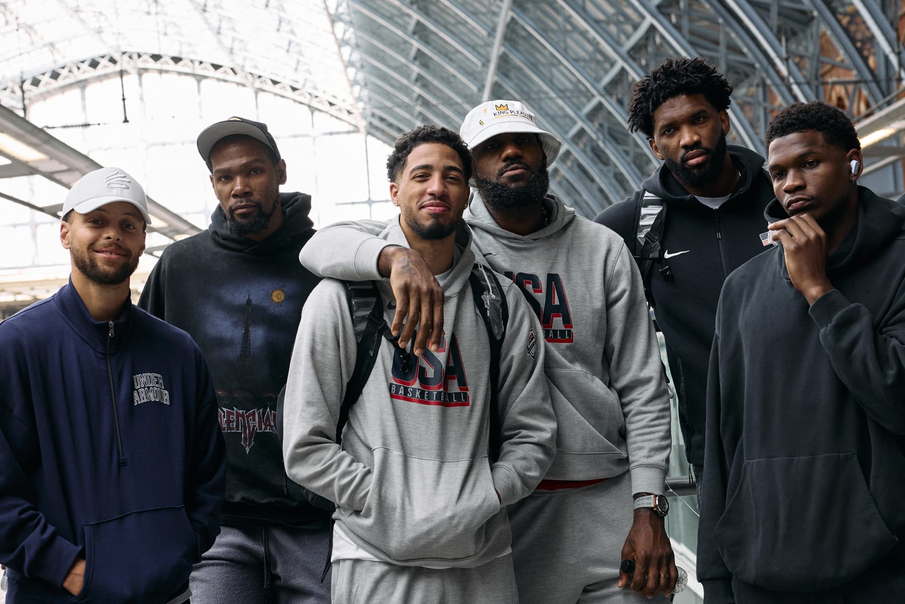 Members of the US Olympic Basketball team, Stephen Curry, Kevin Durant, Tyrese Haliburton, Lebron James, Joel Embiid, and Anthony Edwards, pose for a photo before boarding an Olympic-themed Golden Train as they prepare to travel to Paris to attend the Paris 2024 Olympic Games, from the Eurostar departures terminal at St Pancras International train station in London on July 24, 2024. (Photo by BENJAMIN CREMEL / AFP) (Photo by BENJAMIN CREMEL/AFP via Getty Images)