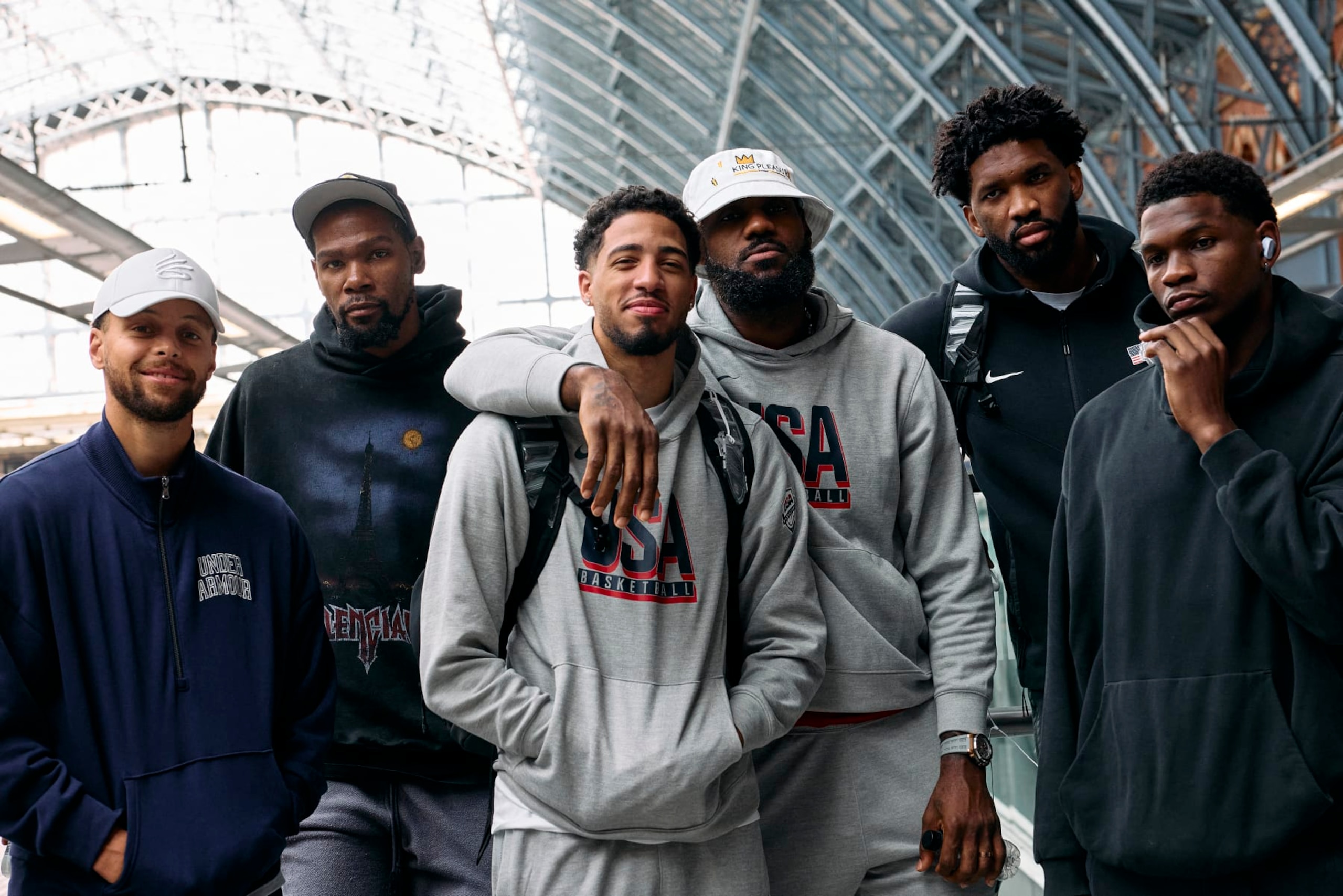 Members of the US Olympic Basketball team, Stephen Curry, Kevin Durant, Tyrese Haliburton, Lebron James, Joel Embiid, and Anthony Edwards, pose for a photo before boarding an Olympic-themed Golden Train as they prepare to travel to Paris to attend the Paris 2024 Olympic Games, from the Eurostar departures terminal at St Pancras International train station in London on July 24, 2024. (Photo by BENJAMIN CREMEL / AFP) (Photo by BENJAMIN CREMEL/AFP via Getty Images)