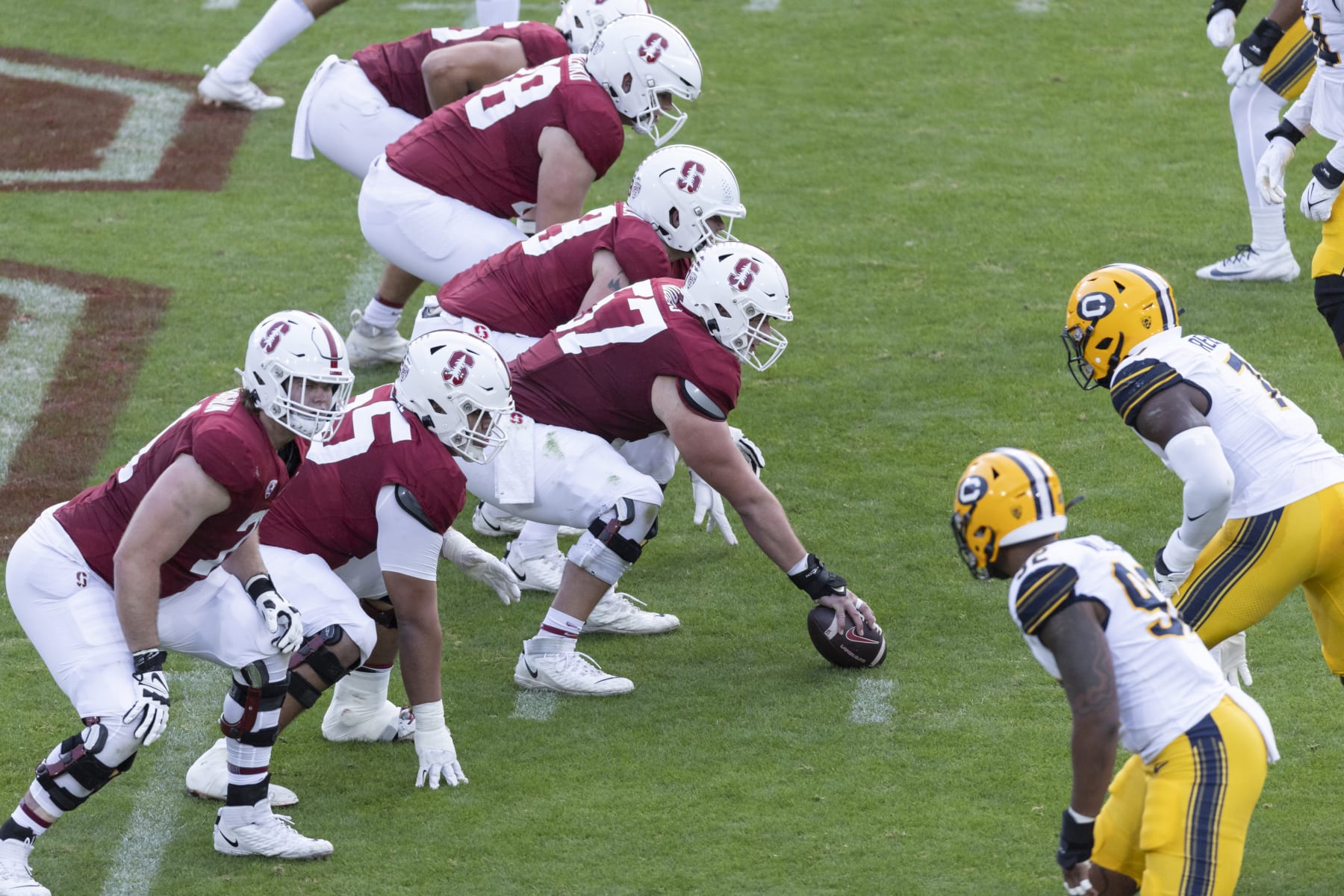 PALO ALTO, CA - NOVEMBER 18: The Stanford Cardinal offensive line prepares for the snap during the 126th Big Game against the California Golden Bears on November 18, 2023 at Stanford Stadium; visible players include Levi Rogers #57, Allen Thomason #65 of Stanford. (Photo by David Madison/Getty Images)