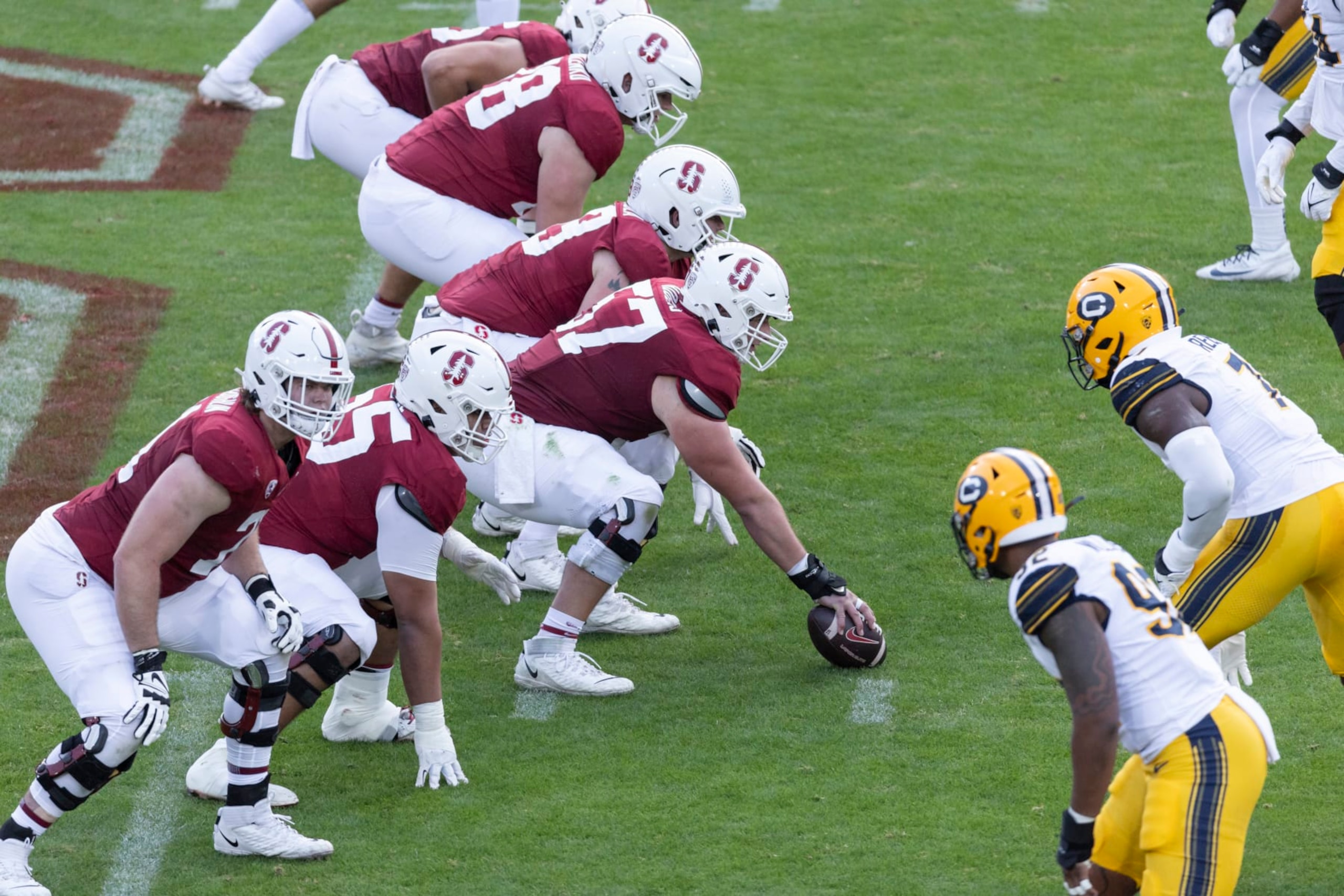 PALO ALTO, CA - NOVEMBER 18:  The Stanford Cardinal offensive line prepares for the snap during the 126th Big Game against the California Golden Bears on November 18, 2023 at Stanford Stadium; visible players include Levi Rogers #57, Allen Thomason #65 of Stanford.  (Photo by David Madison/Getty Images)