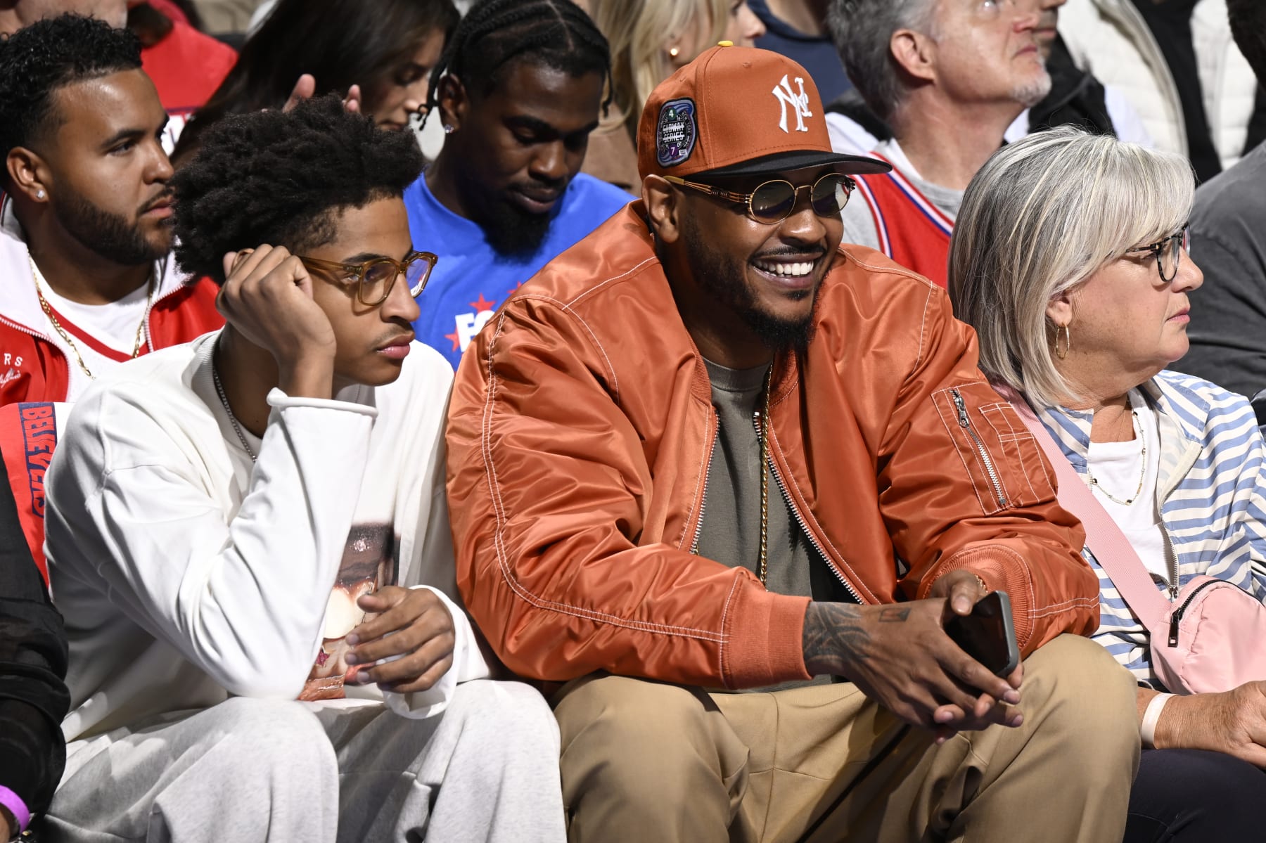 PHILADELPHIA, PA - APRIL 25: Carmelo Anthony and Kiyan Anthony attend the game between the New York Knicks and the Philadelphia 76ers during Round 1 Game 3 of the 2024 NBA Playoffs on April 25, 2024 at the Wells Fargo Center in Philadelphia, Pennsylvania NOTE TO USER: User expressly acknowledges and agrees that, by downloading and/or using this Photograph, user is consenting to the terms and conditions of the Getty Images License Agreement. Mandatory Copyright Notice: Copyright 2024 NBAE (Photo by David Dow/NBAE via Getty Images)