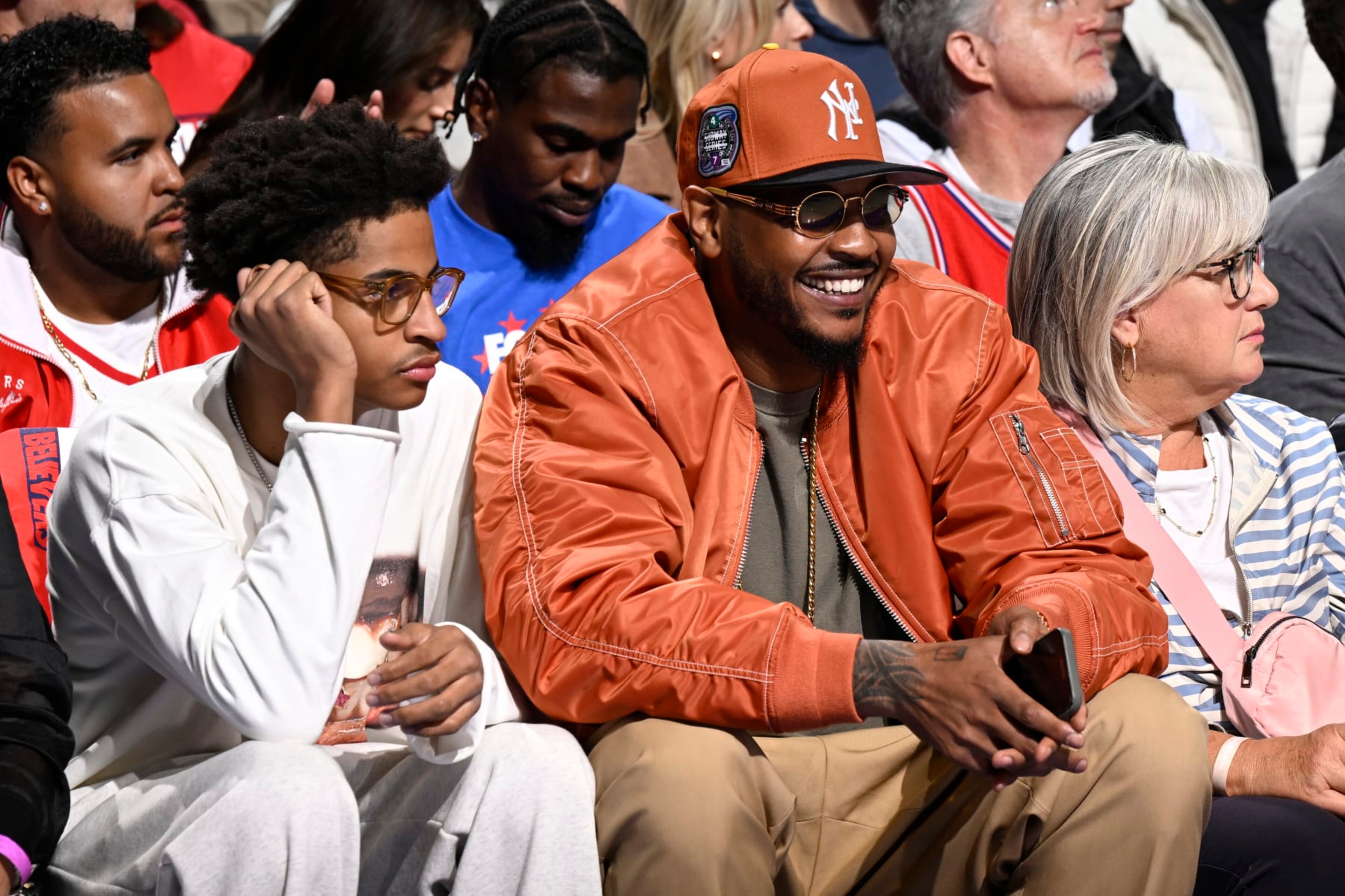 PHILADELPHIA, PA - APRIL 25: Carmelo Anthony and Kiyan Anthony attend the game between the New York Knicks and the Philadelphia 76ers during Round 1 Game 3 of the 2024 NBA Playoffs on April 25, 2024 at the Wells Fargo Center in Philadelphia, Pennsylvania NOTE TO USER: User expressly acknowledges and agrees that, by downloading and/or using this Photograph, user is consenting to the terms and conditions of the Getty Images License Agreement. Mandatory Copyright Notice: Copyright 2024 NBAE (Photo by David Dow/NBAE via Getty Images) PHILADELPHIA, PA - APRIL 25: Carmelo Anthony and Kiyan Anthony attend the game between the New York Knicks and the Philadelphia 76ers during Round 1 Game 3 of the 2024 NBA Playoffs on April 25, 2024 at the Wells Fargo Center in Philadelphia, Pennsylvania NOTE TO USER: User expressly acknowledges and agrees that, by downloading and/or using this Photograph, user is consenting to the terms and conditions of the Getty Images License Agreement. Mandatory Copyright Notice: Copyright 2024 NBAE (Photo by David Dow/NBAE via Getty Images)