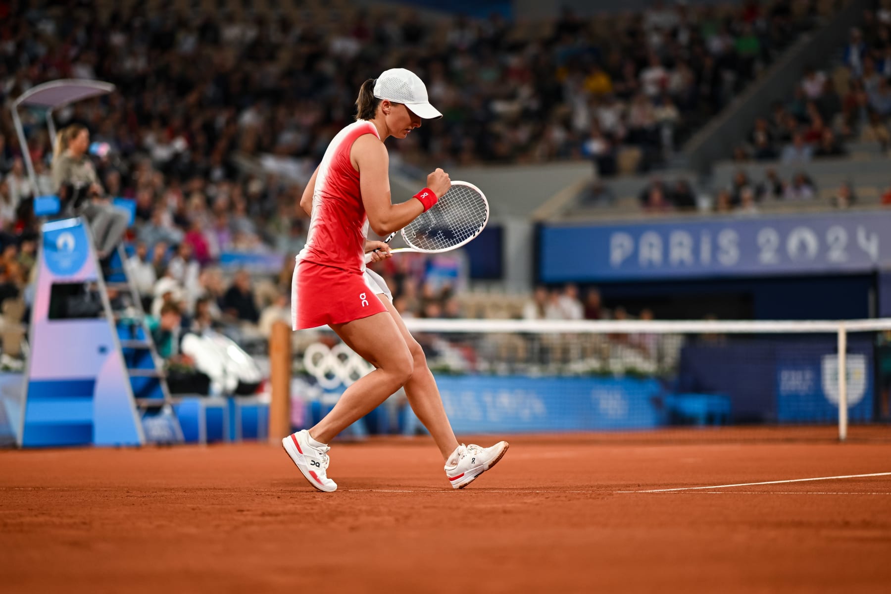 PARIS, FRANCE - JULY 27: Iga Swiatek of Poland reacts against Irina-Camelia Begu of Romania in the Women's Singles first round match on day one of the Olympic Games Paris 2024 at Roland Garros on July 27, 2024 in Paris, France. (Photo by Daniel Kopatsch/Getty Images)