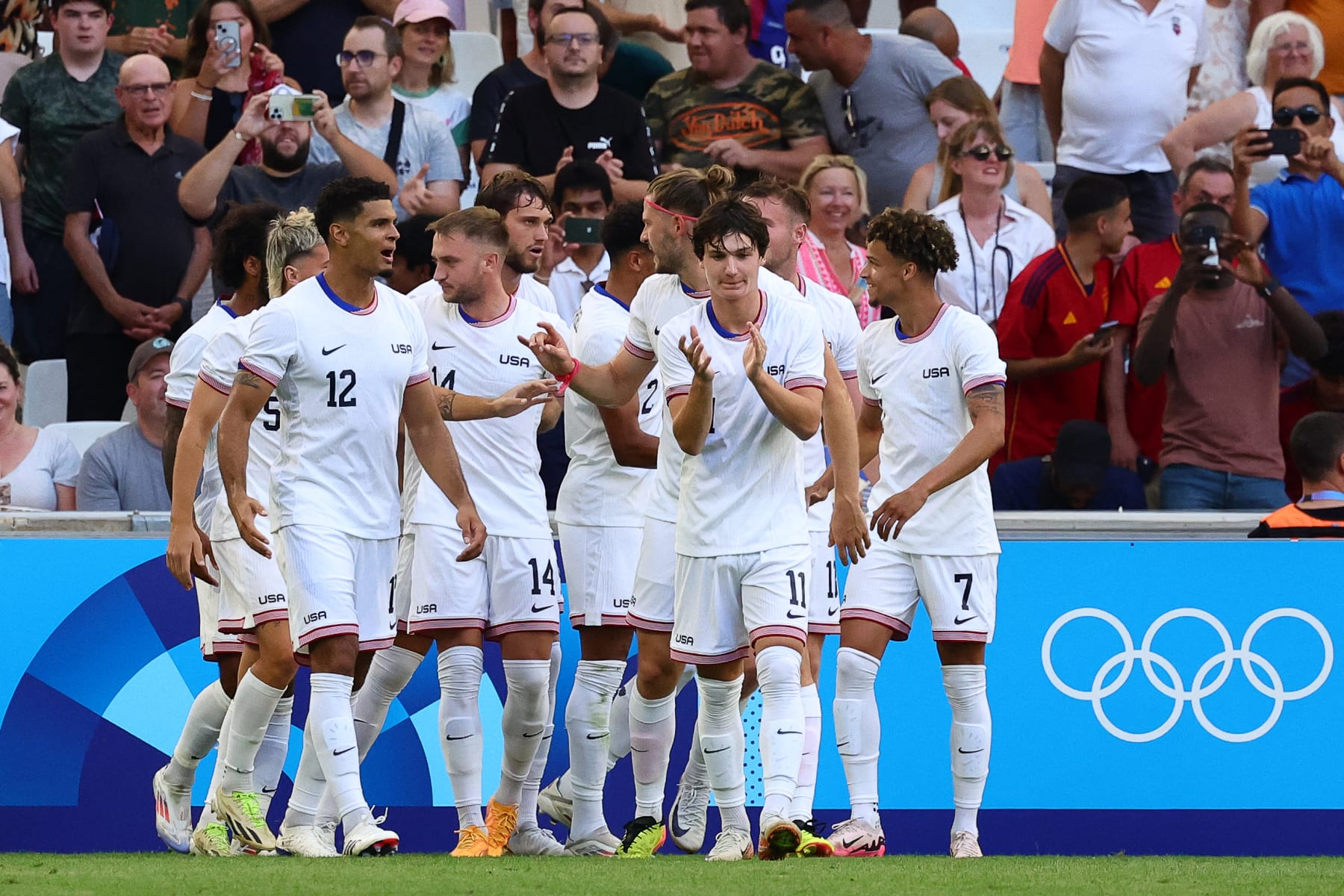 US' midfielder #14 Djordje Mihailovic celebrates with teammates after scoring his team's first goal in the men's group A football match between New Zealand and the USA during the Paris 2024 Olympic Games at the Marseille Stadium in Marseille on July 27, 2024. (Photo by Clement MAHOUDEAU / AFP) (Photo by CLEMENT MAHOUDEAU/AFP via Getty Images)