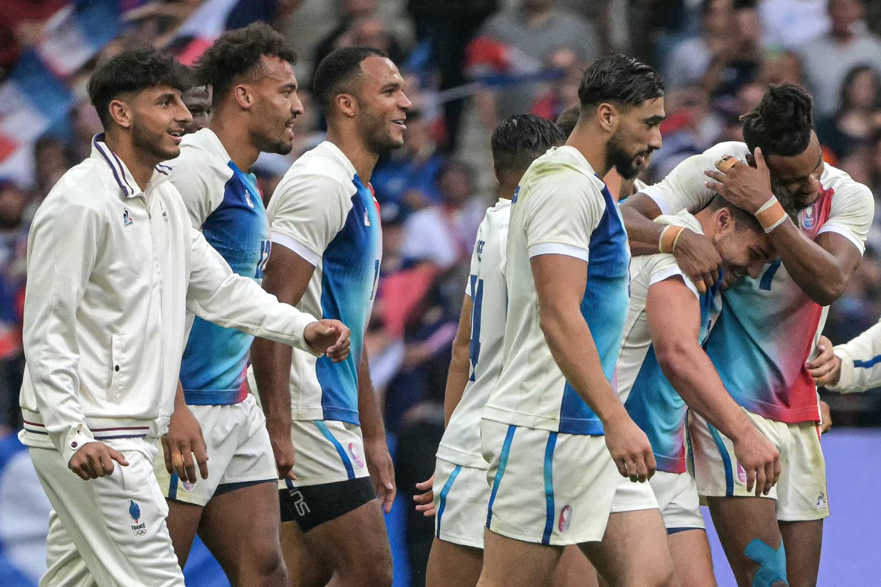 France's Antoine Dupont (2R) and teammates celebrate after the men's gold medal rugby sevens match between France and Fiji during the Paris 2024 Olympic Games at the Stade de France in Saint-Denis on July 27, 2024. (Photo by CARL DE SOUZA / AFP) (Photo by CARL DE SOUZA/AFP via Getty Images)