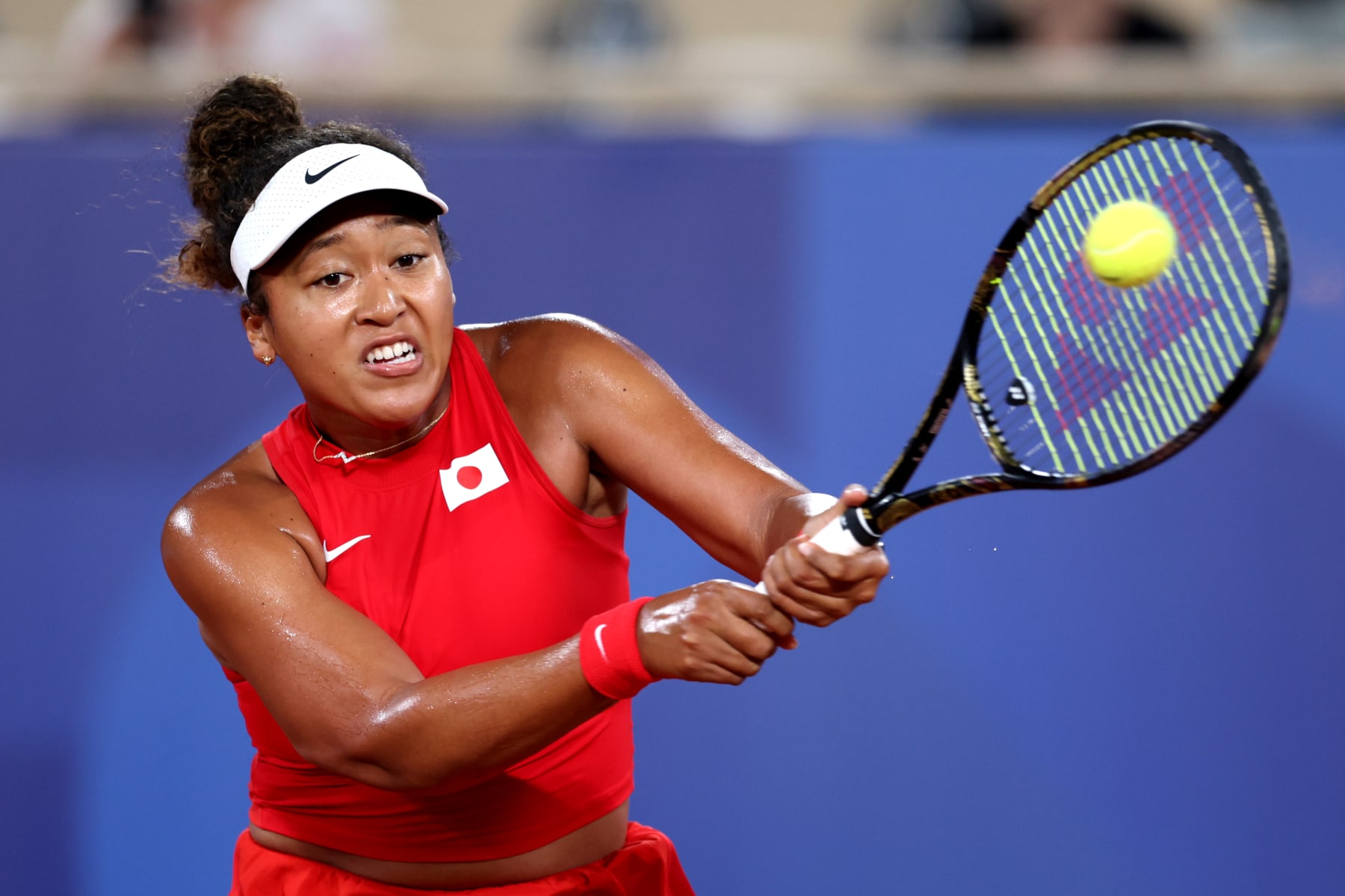 PARIS, FRANCE - JULY 27: Naomi Osaka of Team Japan plays a backhand against Angelique Kerber of Team Germany Women's Singles First Round mach between Naomi Osaka of Team Japan and Angelique Kerber of Team Germany on day one of the Olympic Games Paris 2024 at Roland Garros on July 27, 2024 in Paris, France. (Photo by Clive Brunskill/Getty Images)