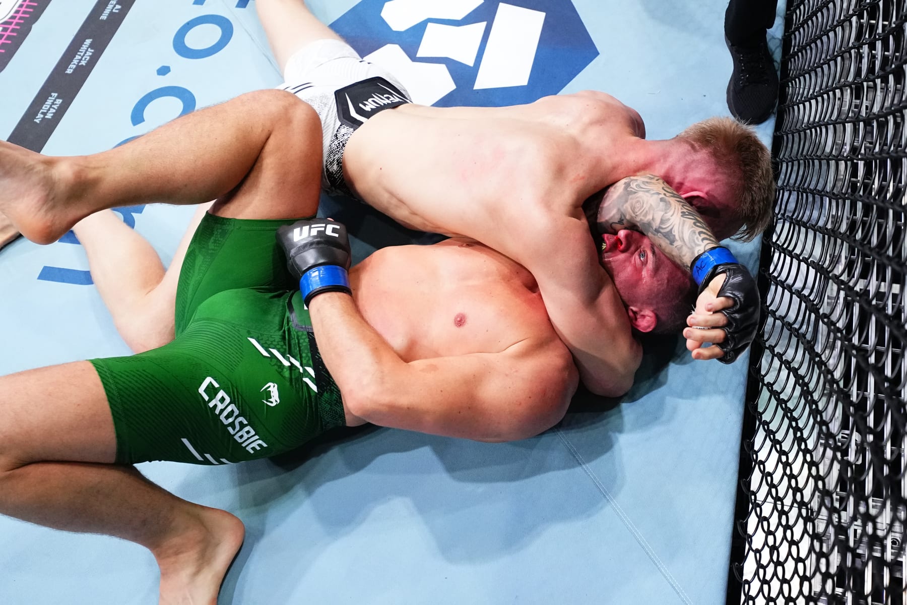 MANCHESTER, ENGLAND - JULY 27: Sam Patterson of England secures an arm triangle choke submission against Kiefer Crosbie of Ireland in a welterweight bout during the UFC 304 event at Co-op Live on July 27, 2024 in Manchester, England. (Photo by Chris Unger/Zuffa LLC via Getty Images)