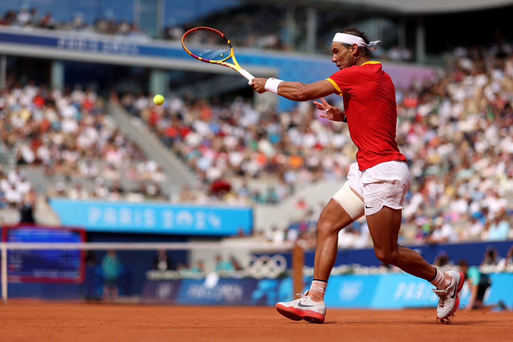 PARIS, FRANCE - JULY 28: Rafael Nadal of Team Spain plays a forehand against Marton Fucsovics of Team Hungary during the Men’s Singles first round match on day two of the Olympic Games Paris 2024 at Roland Garros on July 28, 2024 in Paris, France. (Photo by Clive Brunskill/Getty Images)