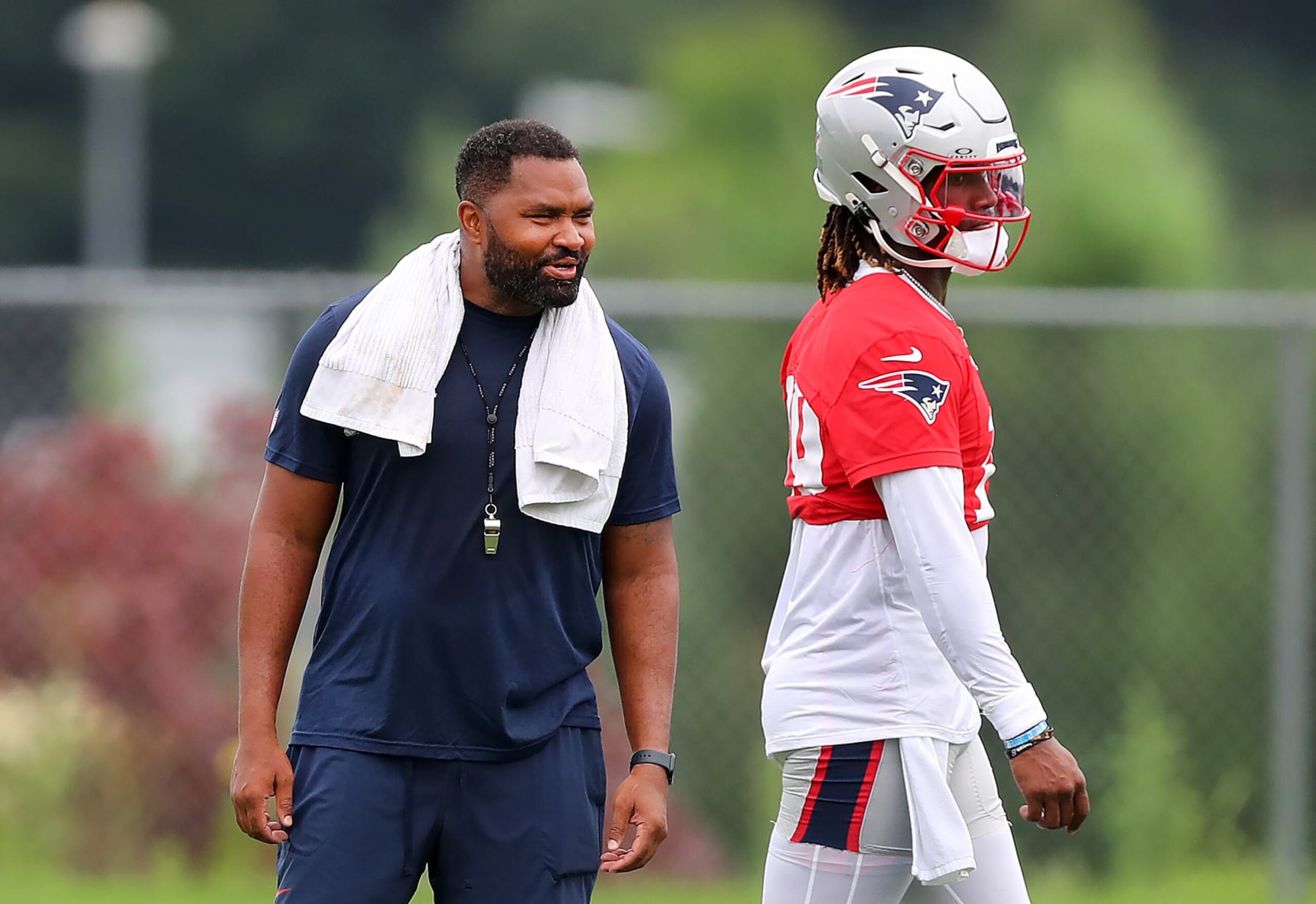 Foxborough, MA - July 25: New England Patriots head coach Jerod Mayo talks with QB Joe Milton III during practice. (Photo by John Tlumacki/The Boston Globe via Getty Images)