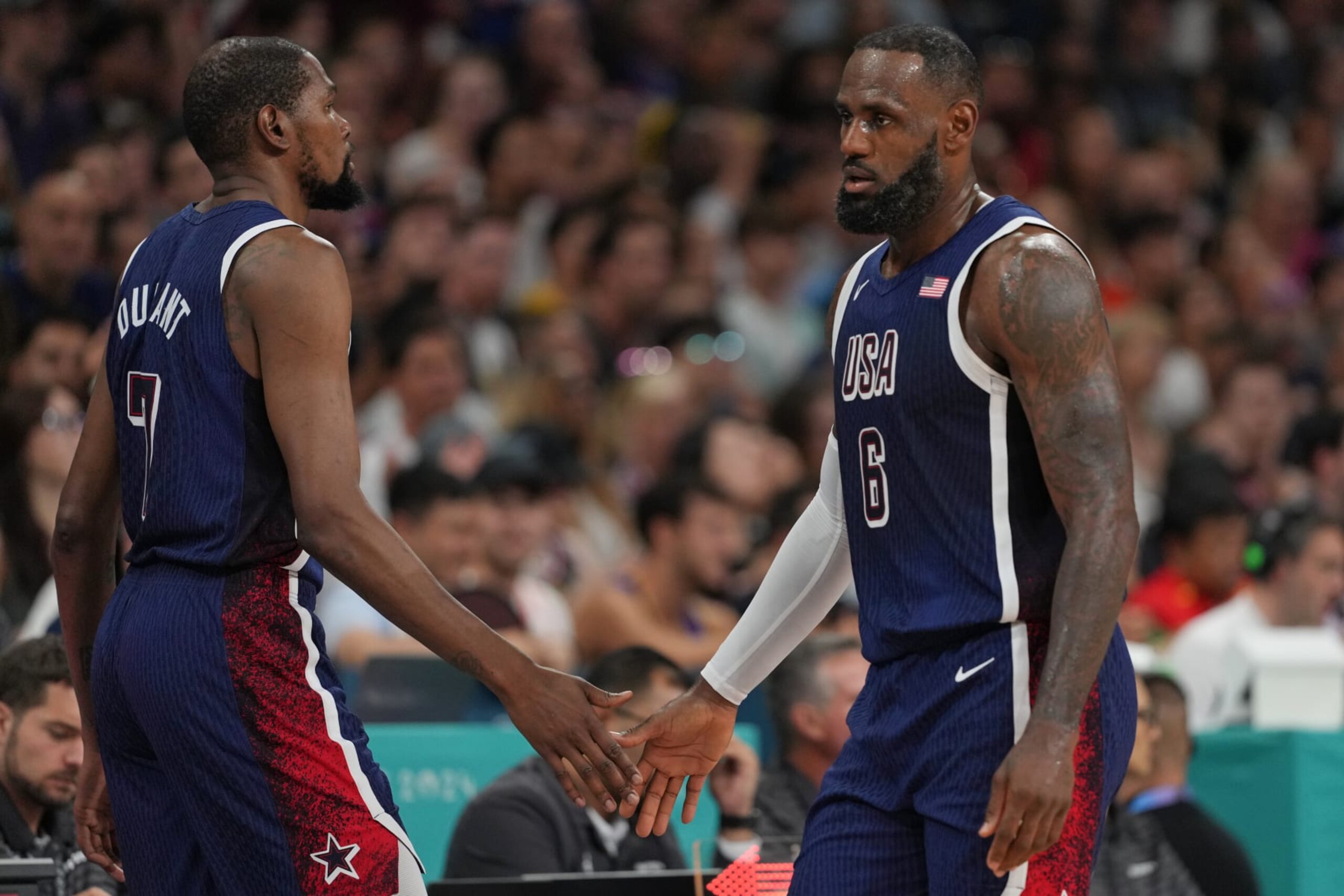 LILLE, FRANCE - JULY 28: LeBron James #6 and Kevin Durant #7 of Team USA high five during the game against the Serbian Men's National Team on July 28, 2024 at the Stade Pierre Mauroy in Paris, France. NOTE TO USER: User expressly acknowledges and agrees that, by downloading and/or using this photograph, user is consenting to the terms and conditions of the Getty Images License Agreement. Mandatory Copyright Notice: Copyright 2024 NBAE (Photo by Jesse D. Garrabrant/NBAE via Getty Images) LILLE, FRANCE - JULY 28: LeBron James #6 and Kevin Durant #7 of Team USA high five during the game against the Serbian Men's National Team on July 28, 2024 at the Stade Pierre Mauroy in Paris, France. NOTE TO USER: User expressly acknowledges and agrees that, by downloading and/or using this photograph, user is consenting to the terms and conditions of the Getty Images License Agreement. Mandatory Copyright Notice: Copyright 2024 NBAE (Photo by Jesse D. Garrabrant/NBAE via Getty Images)
