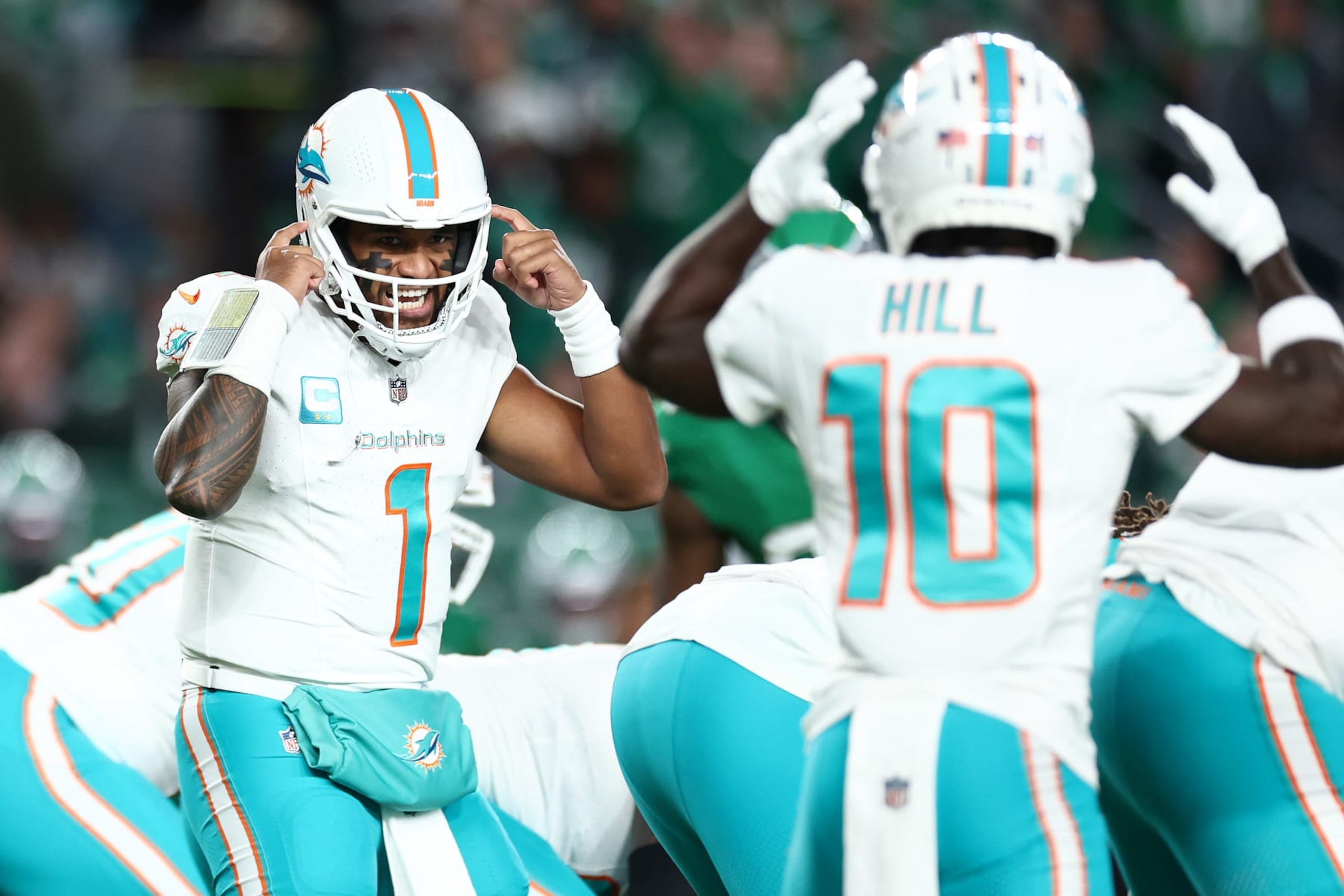 PHILADELPHIA, PENNSYLVANIA - OCTOBER 22: Tua Tagovailoa #1 calls a play to Tyreek Hill #10 of the Miami Dolphins during the first quarter of a game against the Philadelphia Eagles  at Lincoln Financial Field on October 22, 2023 in Philadelphia, Pennsylvania. (Photo by Tim Nwachukwu/Getty Images)