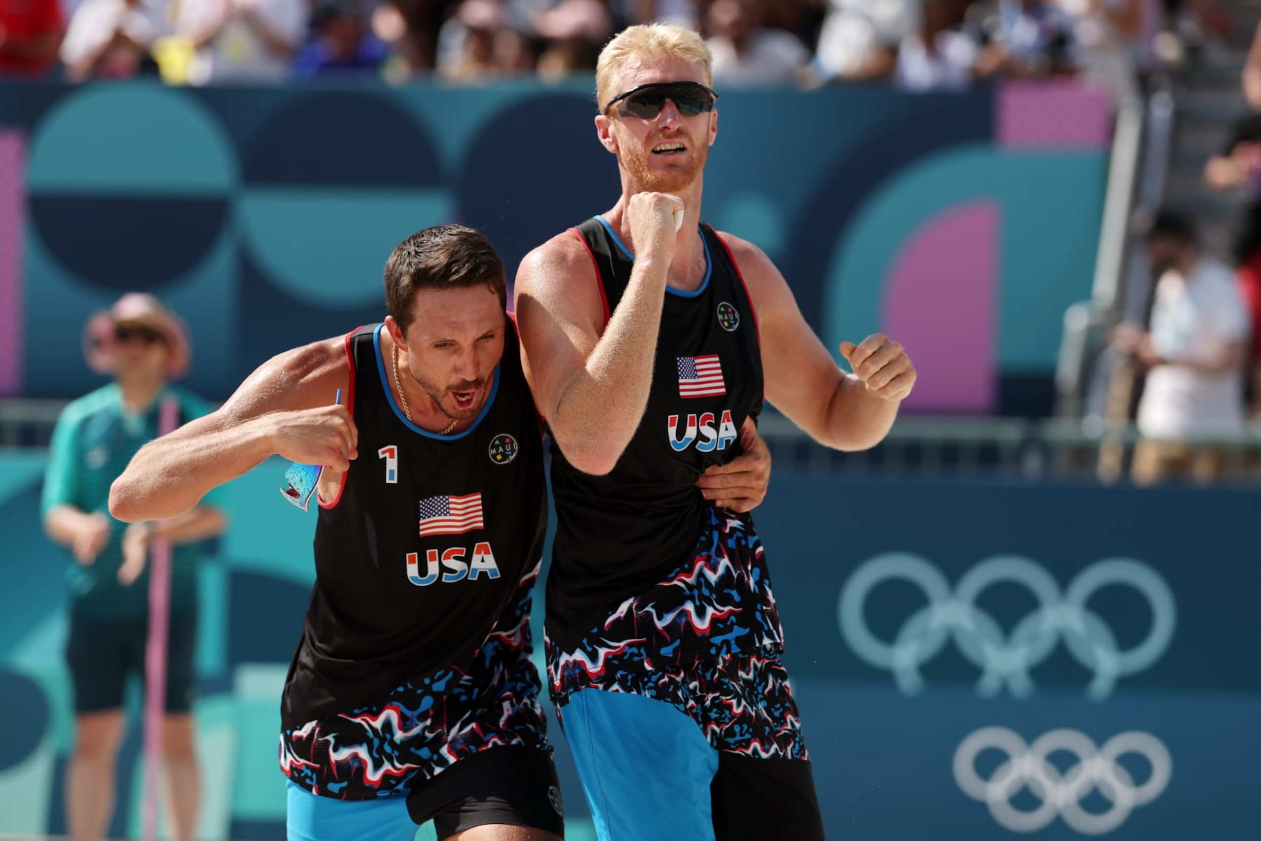 PARIS, FRANCE - JULY 29: Miles Evans and Chase Budinger of Team United States celebrate after defeating Team France during the Men's Preliminary Phase - Pool F match on day three of the Olympic Games Paris 2024 at Eiffel Tower Stadium on July 29, 2024 in Paris, France. (Photo by Michael Reaves/Getty Images)
