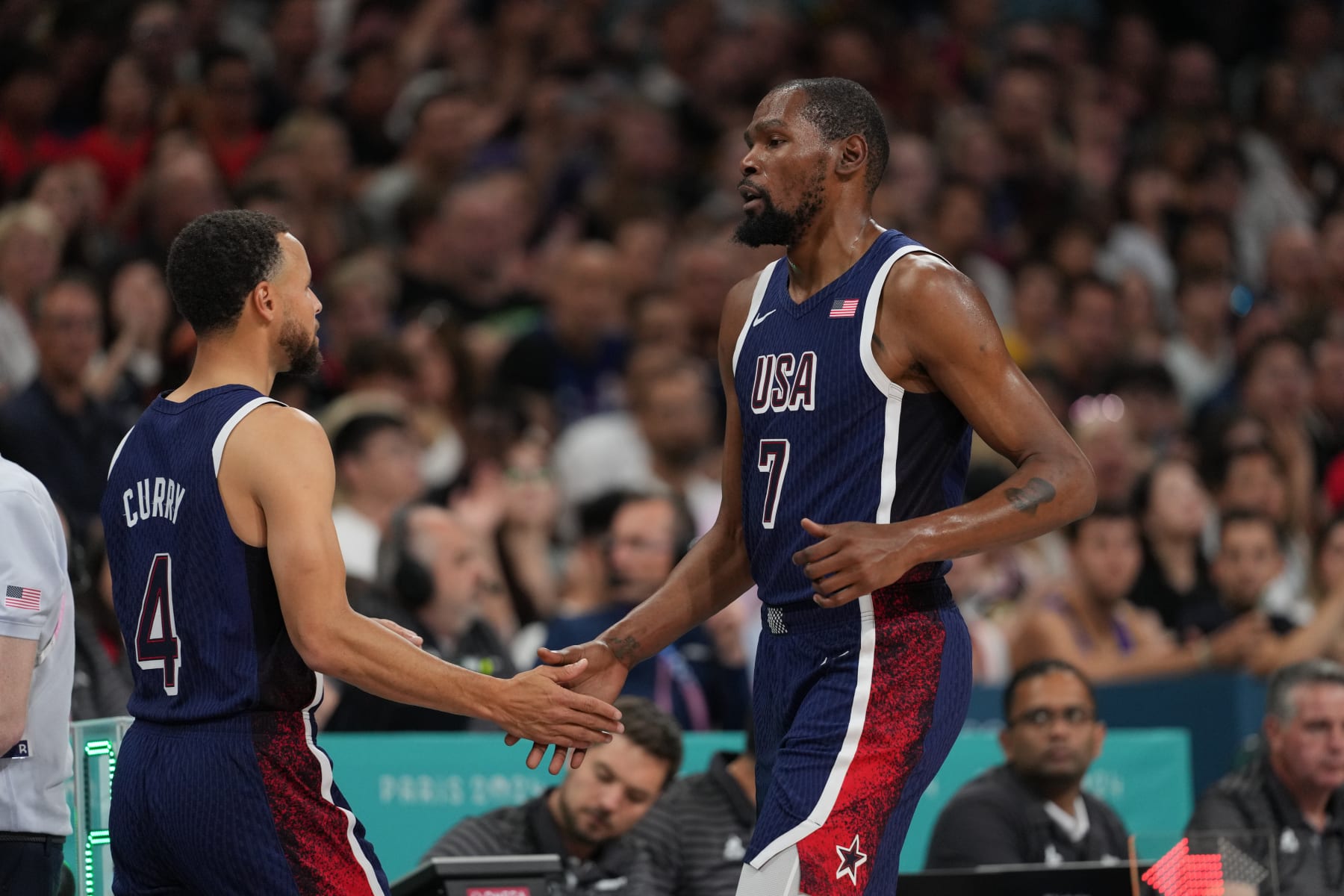 LILLE, FRANCE - JULY 28: Kevin Durant #7 and Stephen Curry #4 of Team USA high five during the game against the Serbian Men's National Team on July 28, 2024 at the Stade Pierre Mauroy in Paris, France. NOTE TO USER: User expressly acknowledges and agrees that, by downloading and/or using this photograph, user is consenting to the terms and conditions of the Getty Images License Agreement. Mandatory Copyright Notice: Copyright 2024 NBAE (Photo by Jesse D. Garrabrant/NBAE via Getty Images)