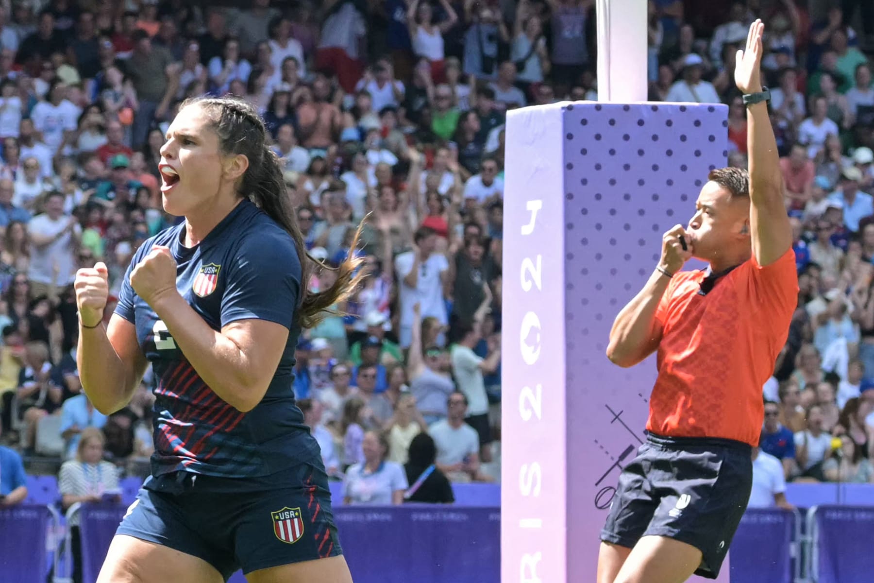 US' Ilona Maher (L) celebrates after scoring a try during the women's pool C rugby sevens match between France and USA during the Paris 2024 Olympic Games at the Stade de France in Saint-Denis on July 29, 2024. (Photo by CARL DE SOUZA / AFP) (Photo by CARL DE SOUZA/AFP via Getty Images)