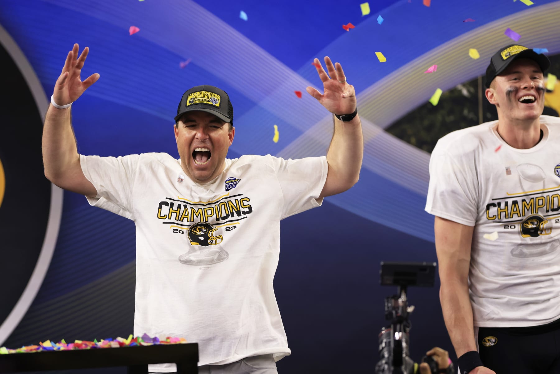 ARLINGTON, TEXAS - DECEMBER 29: Head coach Eliah Drinkwitz and Brady Cook #12 of the Missouri Tigers celebrate after defeating the Ohio State Buckeyes 14-3 in the Goodyear Cotton Bowl at AT&T Stadium on December 29, 2023 in Arlington, Texas. (Photo by Ron Jenkins/Getty Images)