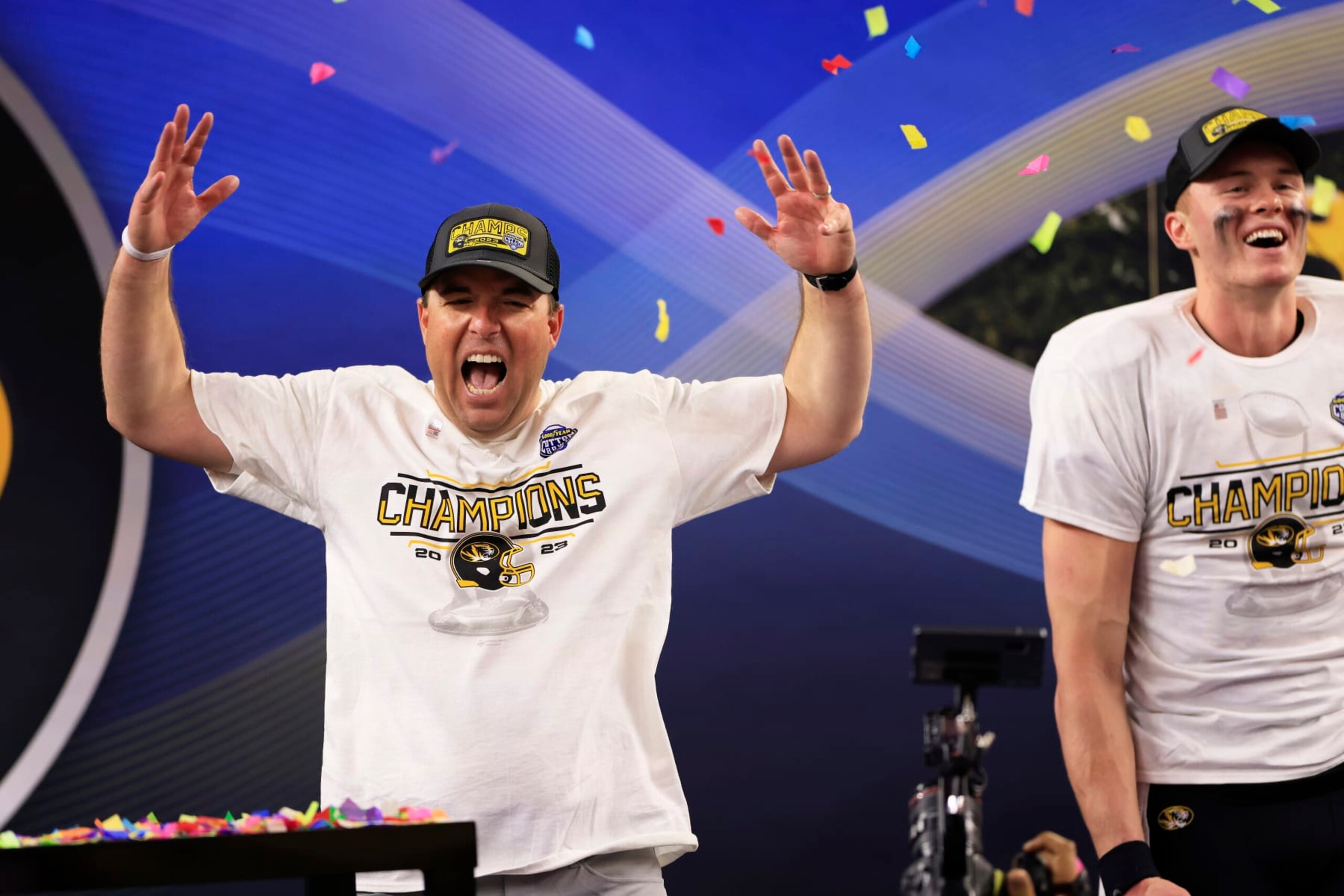 ARLINGTON, TEXAS - DECEMBER 29: Head coach Eliah Drinkwitz and Brady Cook #12 of the Missouri Tigers celebrate after defeating the Ohio State Buckeyes 14-3 in the Goodyear Cotton Bowl at AT&T Stadium on December 29, 2023 in Arlington, Texas. (Photo by Ron Jenkins/Getty Images)