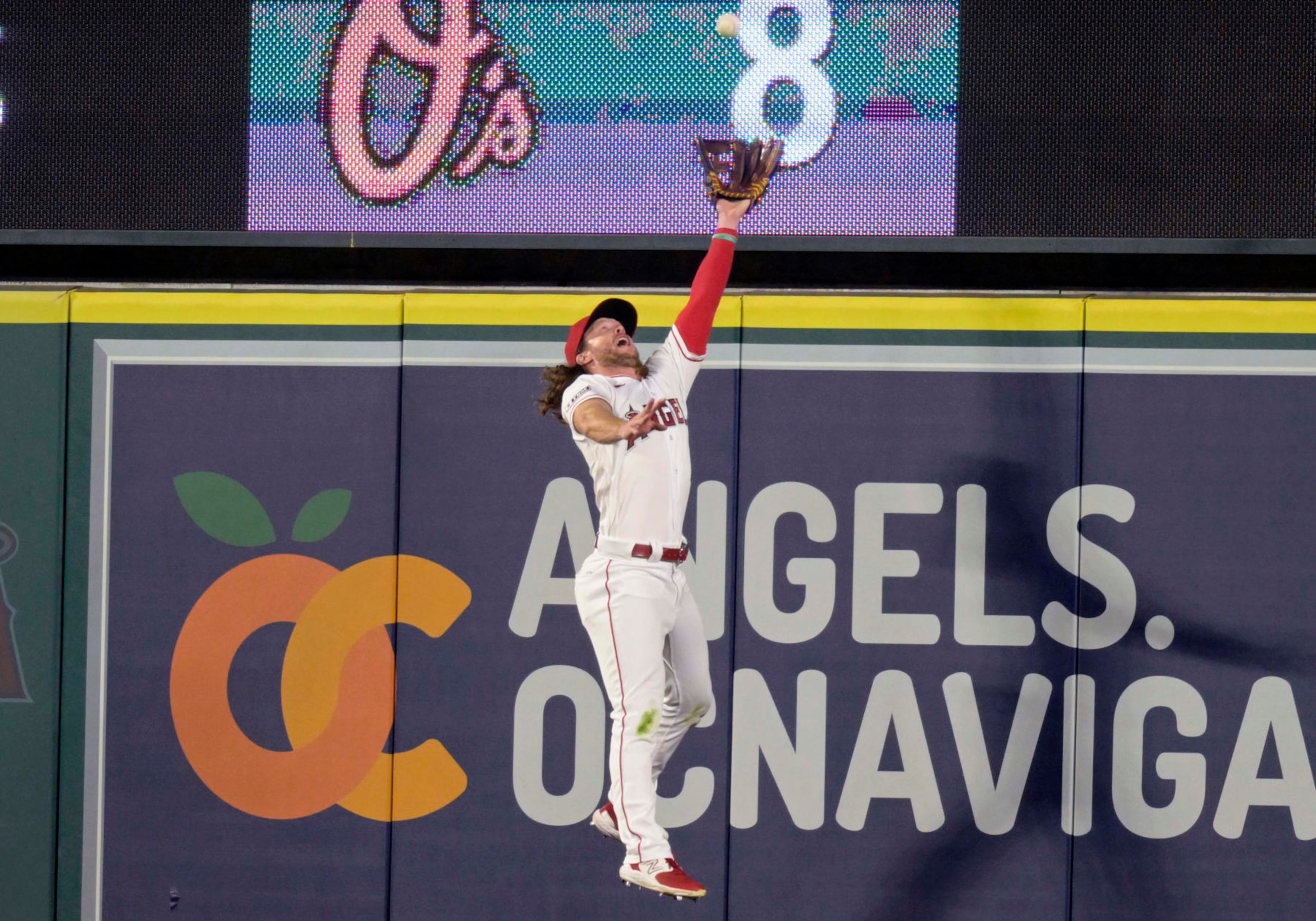 ANAHEIM, CALIFORNIA - SEPTEMBER 16: Brett Phillips #4 of the Los Angeles Angels leaps to catch the ball while playing the Detroit Tigers at Angel Stadium of Anaheim on September 16, 2023 in Anaheim, California. (Photo by John McCoy/Getty Images)