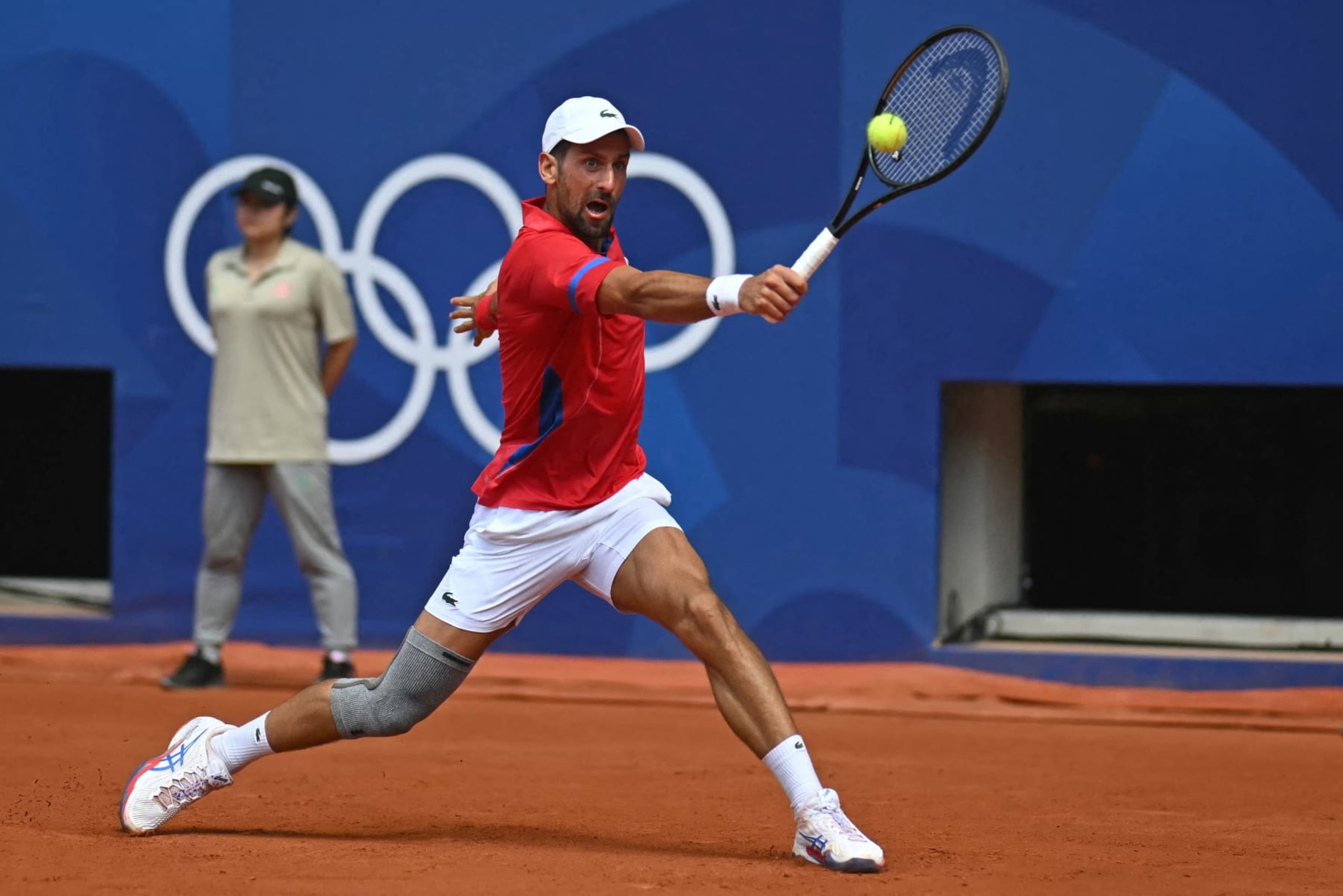 Serbia's Novak Djokovic returns to Germany's Dominik Koepfer during their men's singles third round tennis match on Court Philippe-Chatrier at the Roland-Garros Stadium during the Paris 2024 Olympic Games, in Paris on July 31, 2024. (Photo by CARL DE SOUZA / AFP) (Photo by CARL DE SOUZA/AFP via Getty Images)