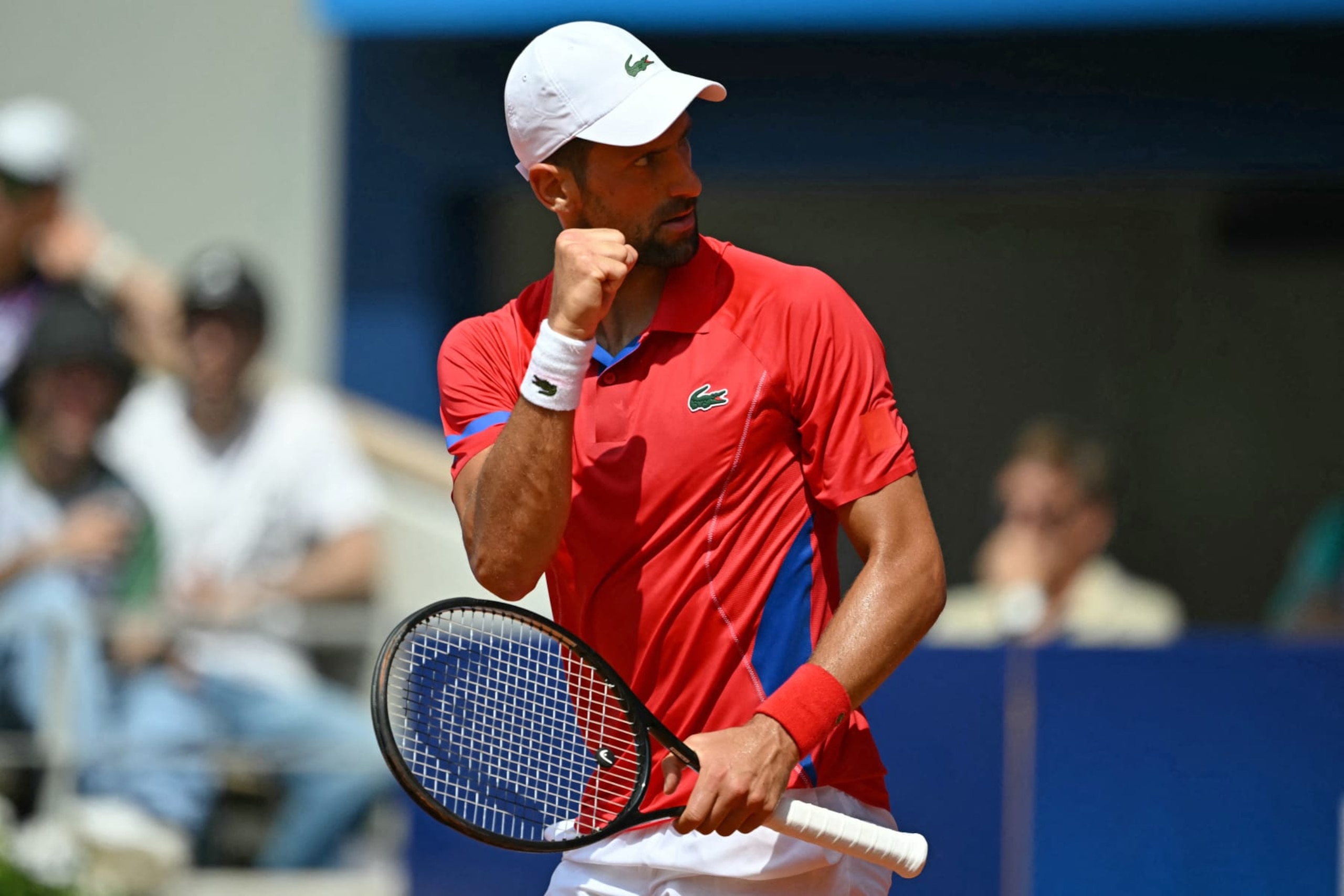 Serbia's Novak Djokovic reacts while playing against Germany's Dominik Koepfer during their men's singles third round tennis match on Court Philippe-Chatrier at the Roland-Garros Stadium during the Paris 2024 Olympic Games, in Paris on July 31, 2024. (Photo by CARL DE SOUZA / AFP) (Photo by CARL DE SOUZA/AFP via Getty Images)