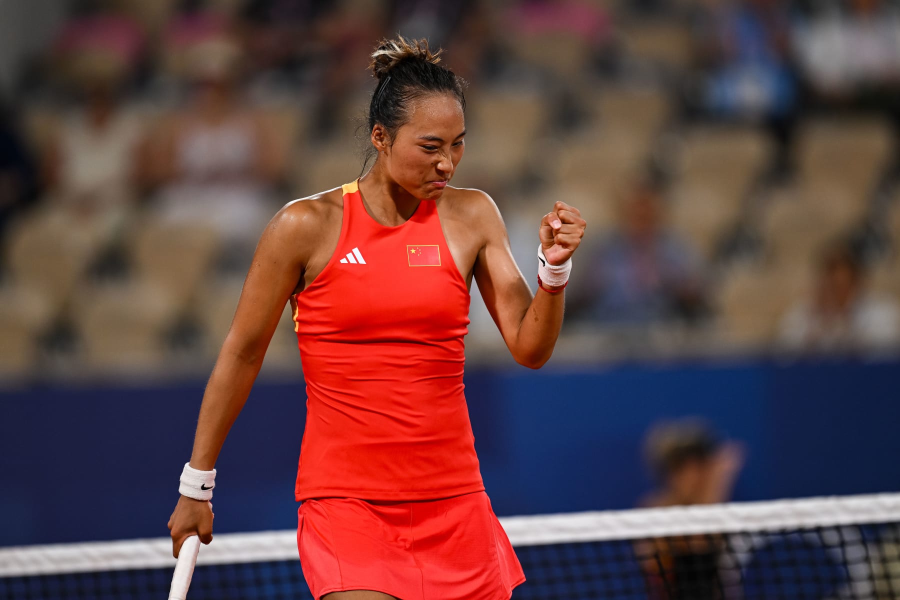 PARIS, FRANCE - JULY 31: Qinwen Zheng of China reacts against Angelique Kerber of Germany in the Women's Quarter Final match on day five of the Olympic Games Paris 2024 at Roland Garros on July 31, 2024 in Paris, France. (Photo by Daniel Kopatsch/Getty Images)