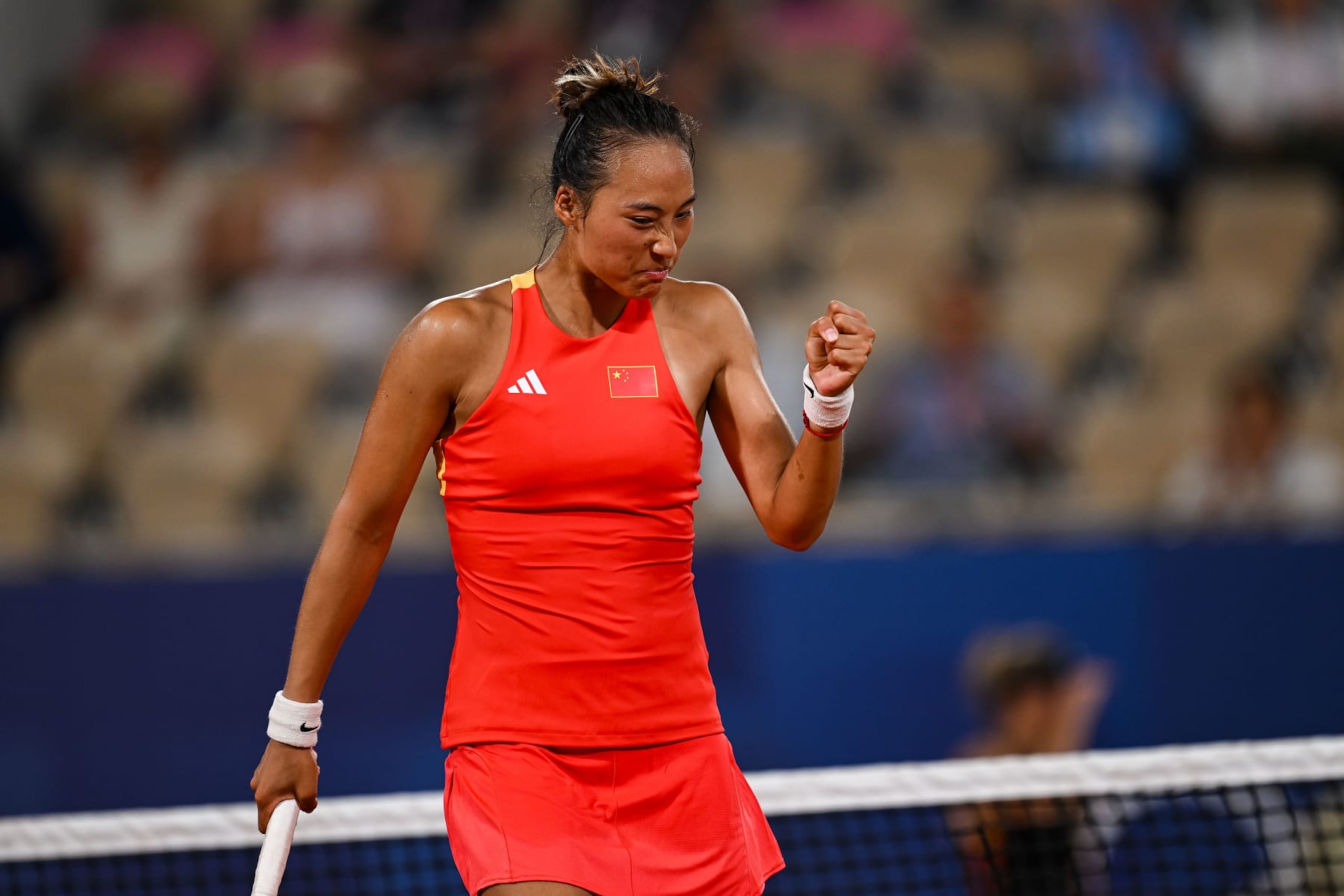 PARIS, FRANCE - JULY 31: Qinwen Zheng of China reacts against Angelique Kerber of Germany in the Women's Quarter Final match on day five of the Olympic Games Paris 2024 at Roland Garros on July 31, 2024 in Paris, France. (Photo by Daniel Kopatsch/Getty Images)