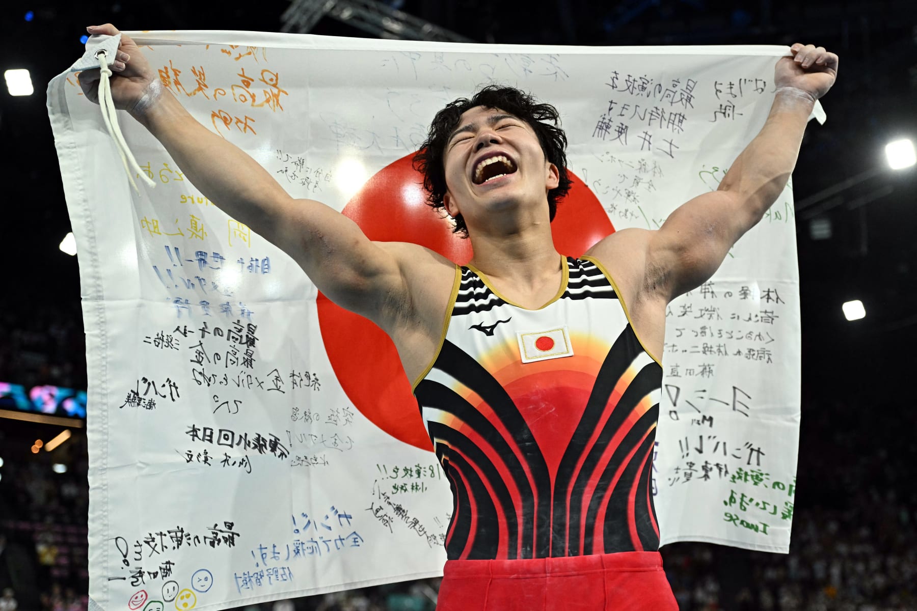 TOPSHOT - Japan's Shinnosuke Oka celebrates after winning the artistic gymnastics men's all-around final during the Paris 2024 Olympic Games at the Bercy Arena in Paris, on July 31, 2024. (Photo by Gabriel BOUYS / AFP) (Photo by GABRIEL BOUYS/AFP via Getty Images)