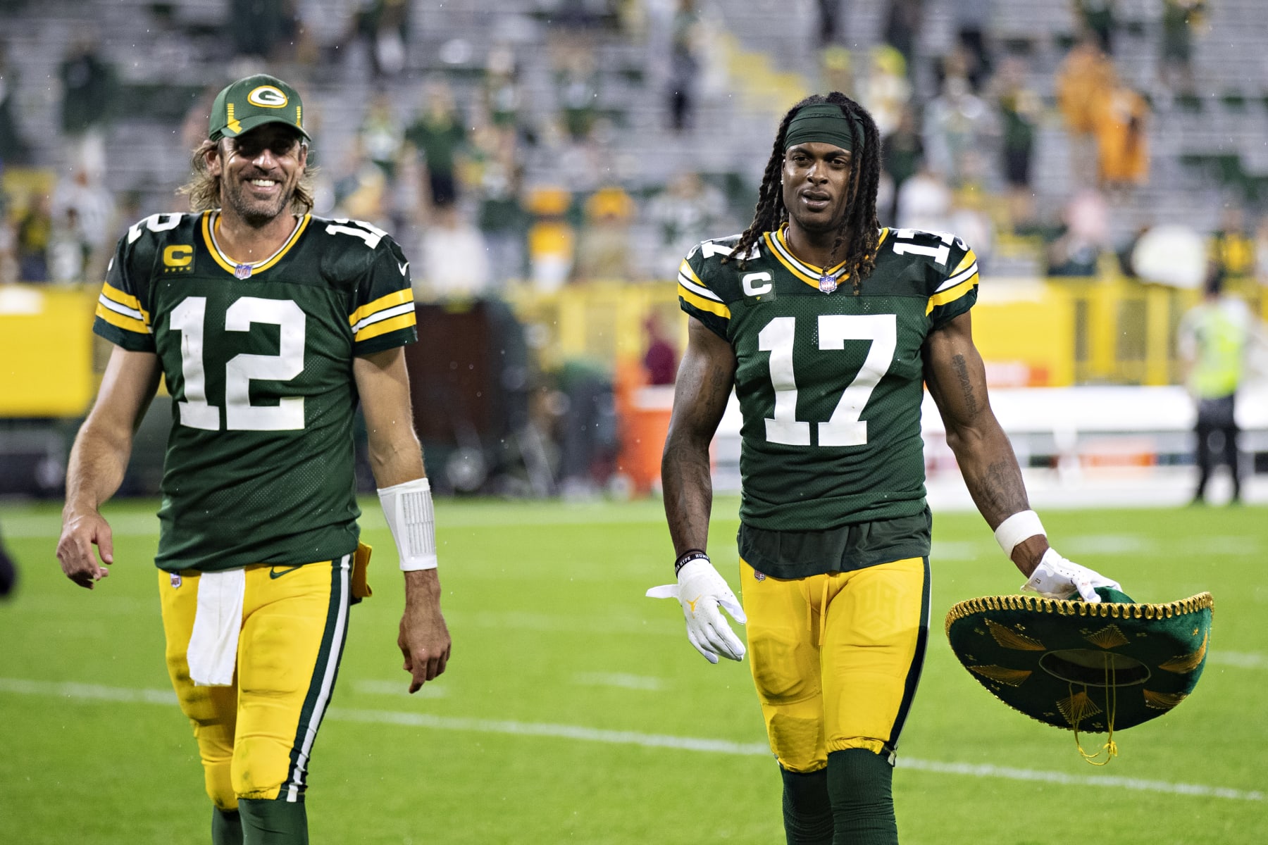 GREEN BAY, WI - SEPTEMBER 20:  Aaron Rodgers #12 and Davante Adams #17 of the Green Bay Packers walk off the field together after a game against the Detroit Lions at Lambeau Field on September 20, 2021 in Green Bay, Wisconsin.  The Packers defeated the Lions 35-17.  (Photo by Wesley Hitt/Getty Images)